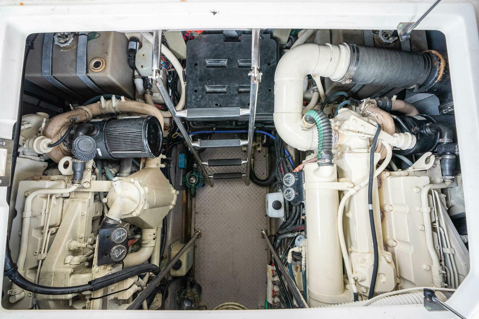 Engine compartment of a 2003 Sea Ray Sundancer 460, showcasing mechanical components and systems.