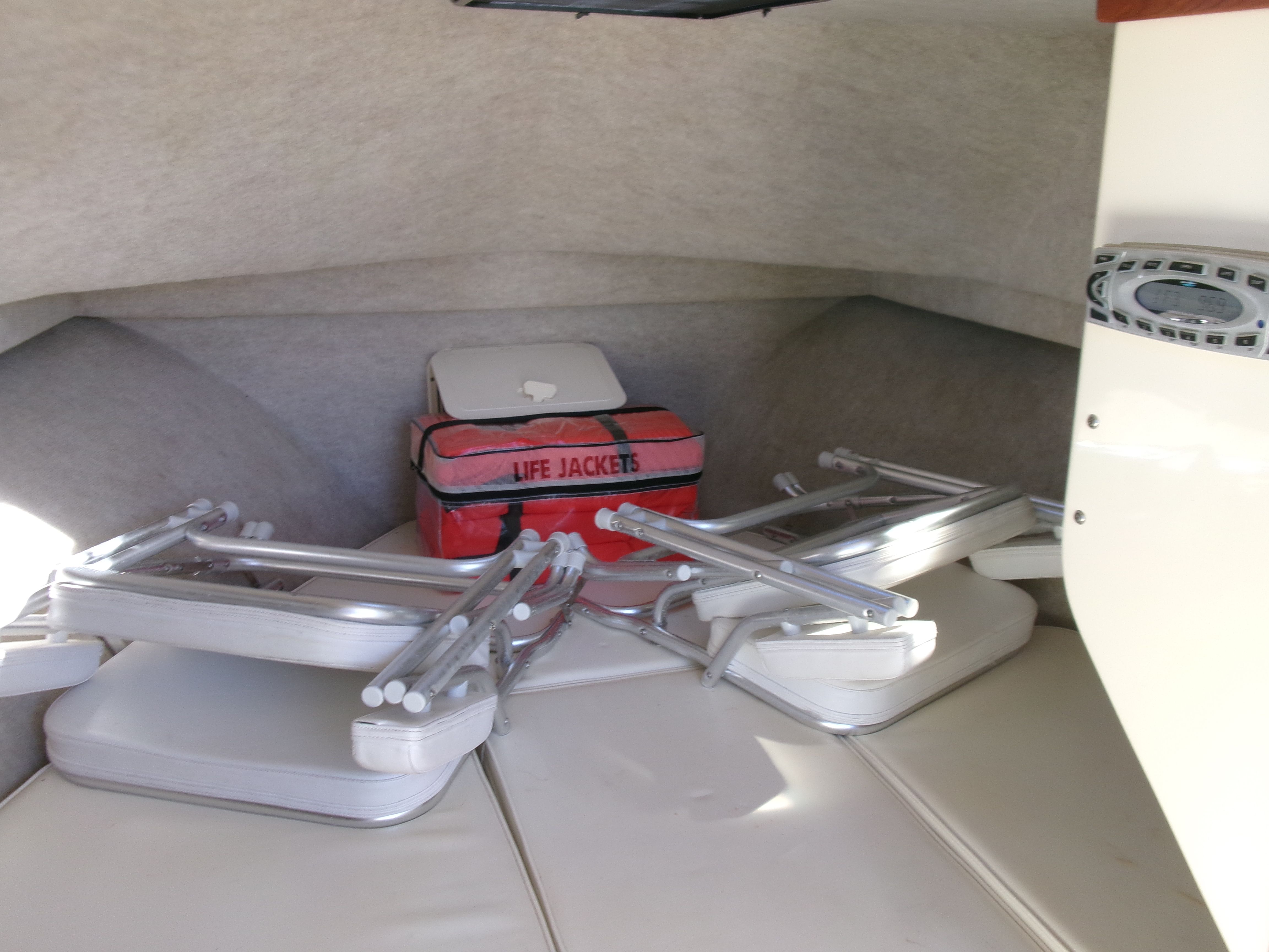 Interior of Parker 2520 XL Sport Cabin with folding chairs and life jackets.