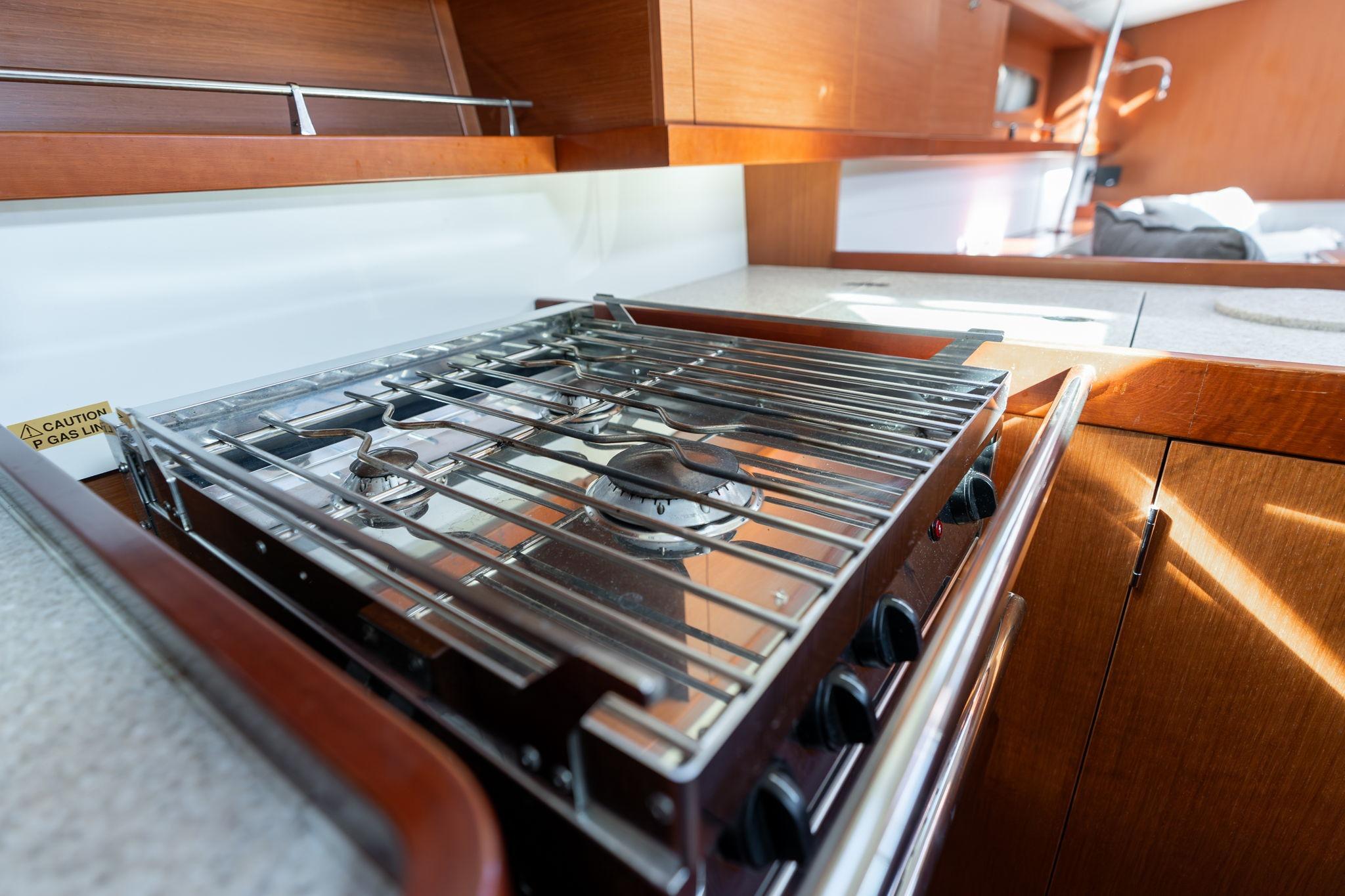 Modern kitchen stove in 2013 Beneteau Oceanis 50 yacht interior.