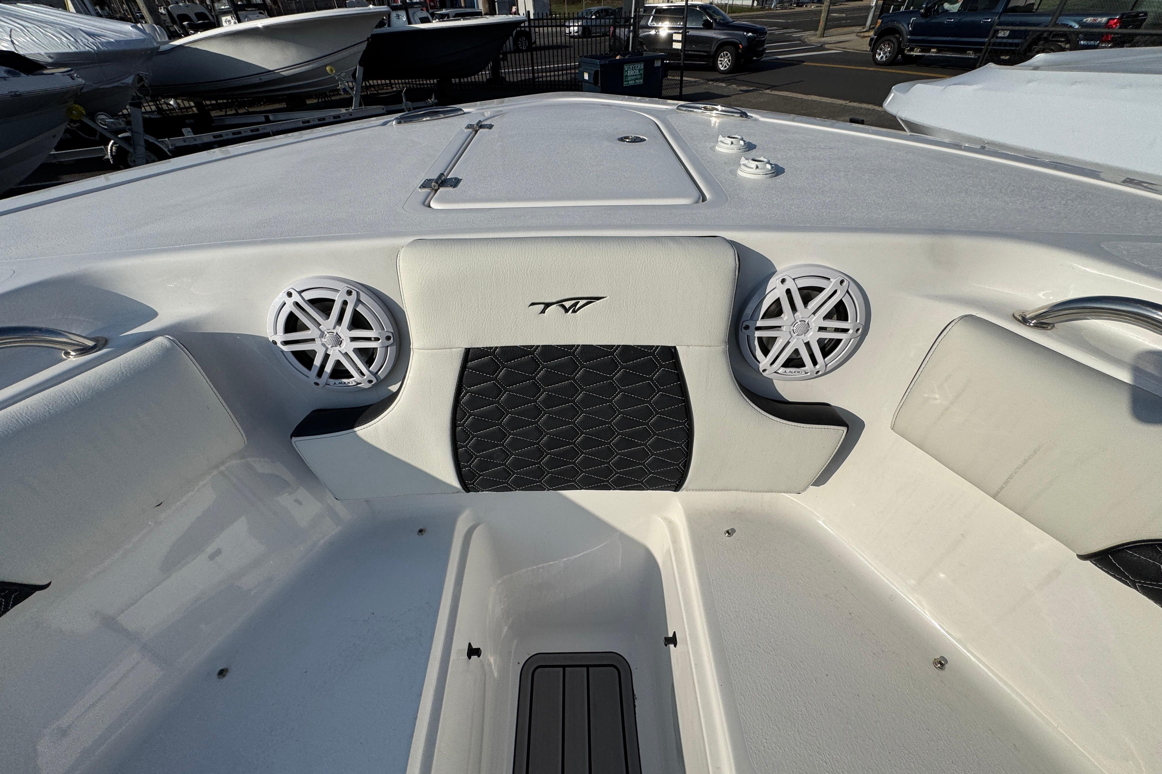 2026 Tidewater 232 SS boat interior with speakers and cushioned seating.