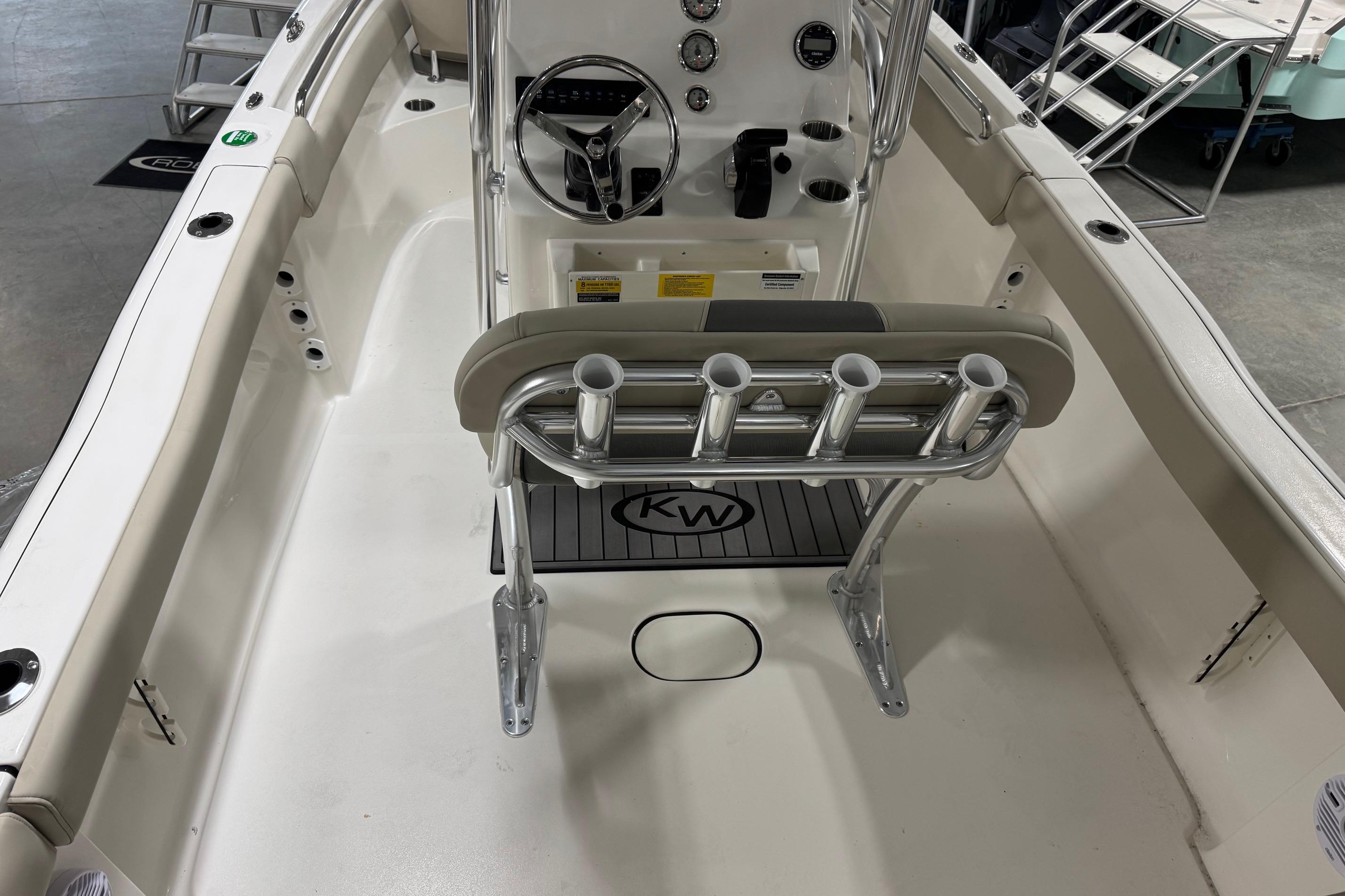 2026 Key West 203 FS boat interior with steering console and rod holders.