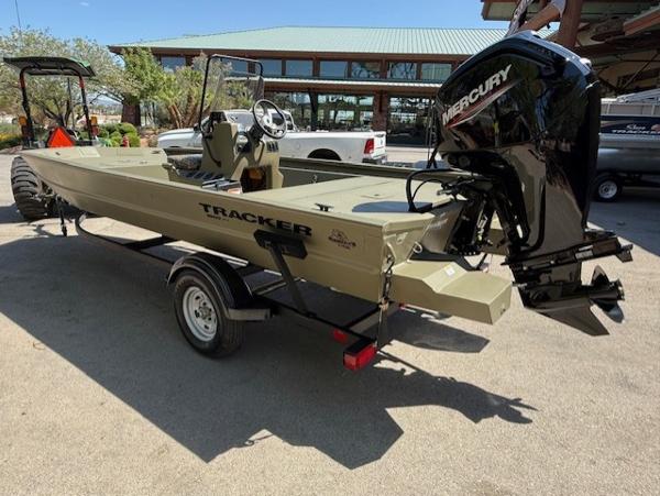 2025 Tracker Grizzly 1860 CC boat with Mercury engine on trailer, parked outdoors.