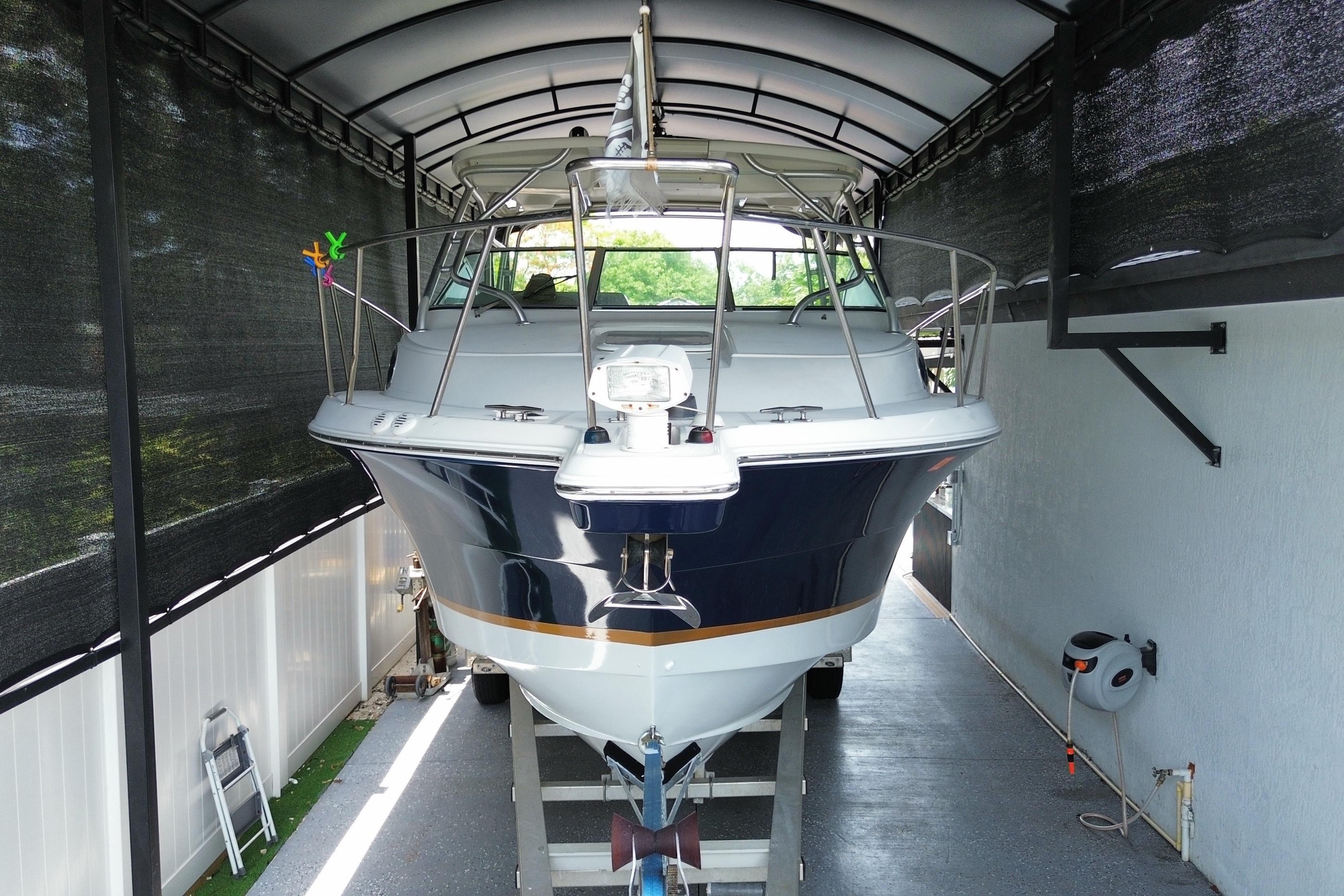 2005 Wellcraft 290 Coastal boat in covered storage, front view.