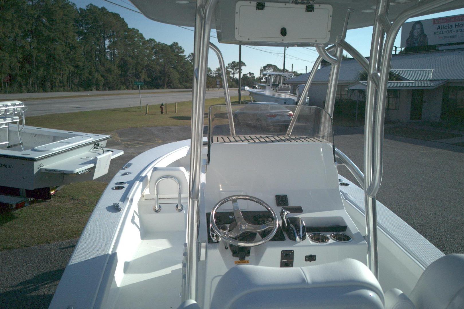 2026 BlackJack 256 Coastal boat interior with steering console and seating.