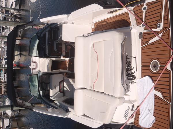 2015 Monterey 288 Super Sport boat with white seating and wood accents docked at marina.