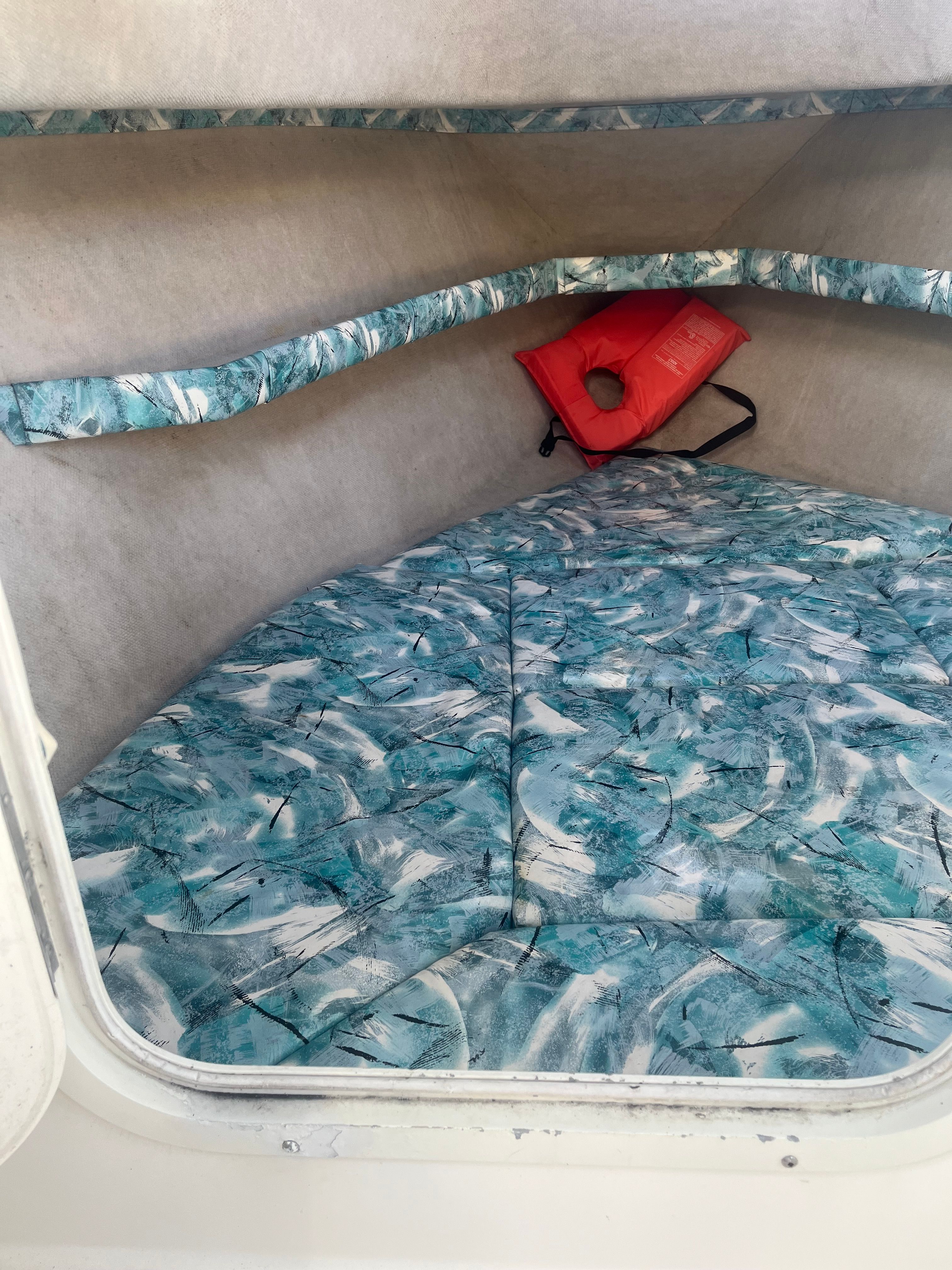 Interior of a 2015 Sea Water Striper with patterned cushions and life jacket.