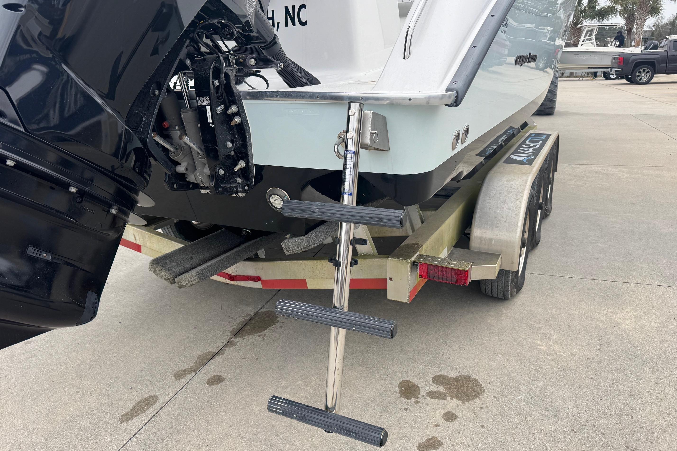 2024 Cape Horn 32 XS boat on trailer with ladder and outboard motor.