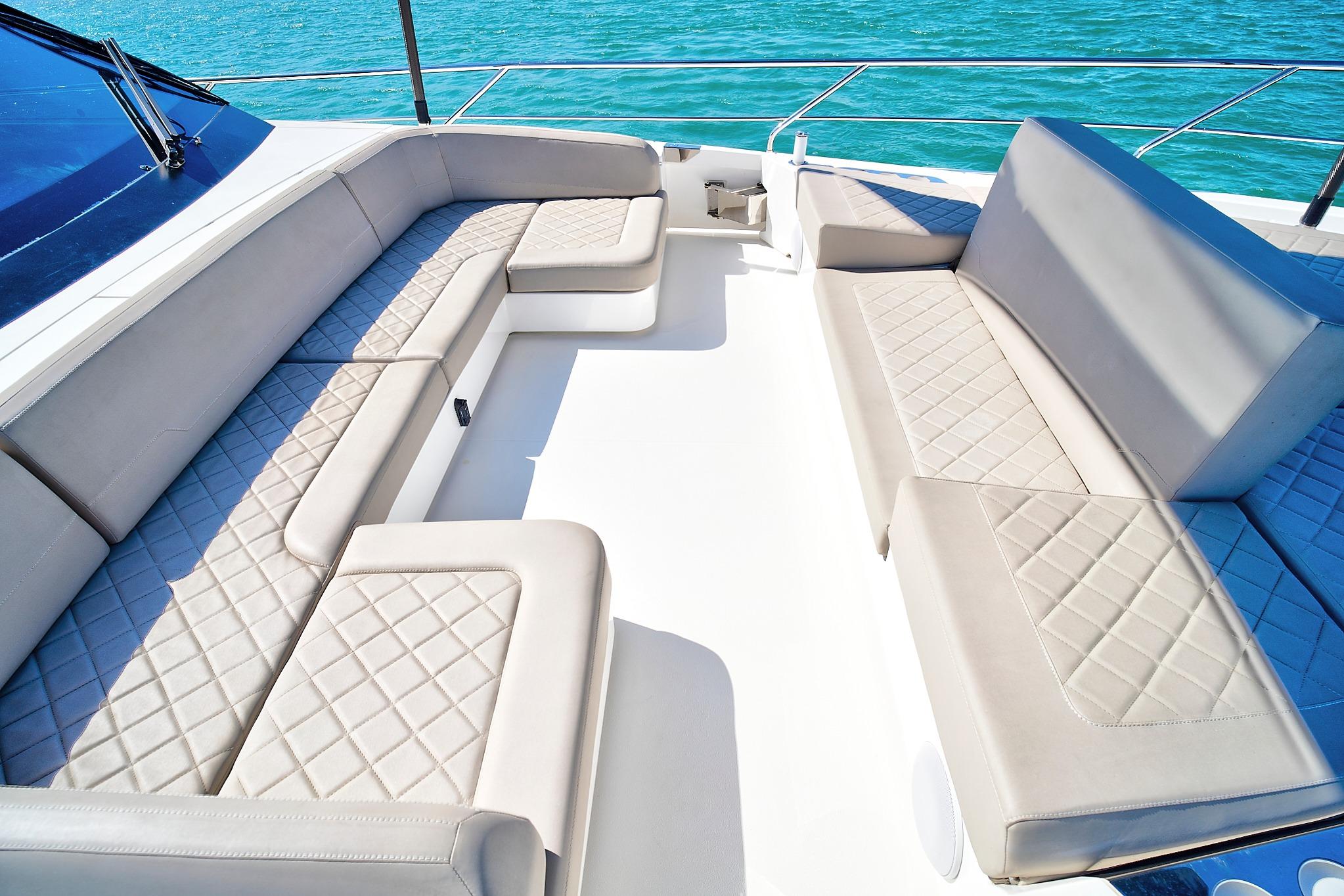 Luxurious seating area on 2021 Fairline Squadron 68 yacht, featuring elegant quilted upholstery.