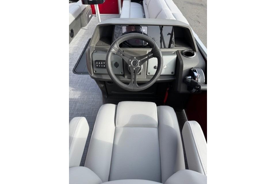 2026 Sun Tracker Party Barge 24 XP3 helm with steering wheel and control panel.