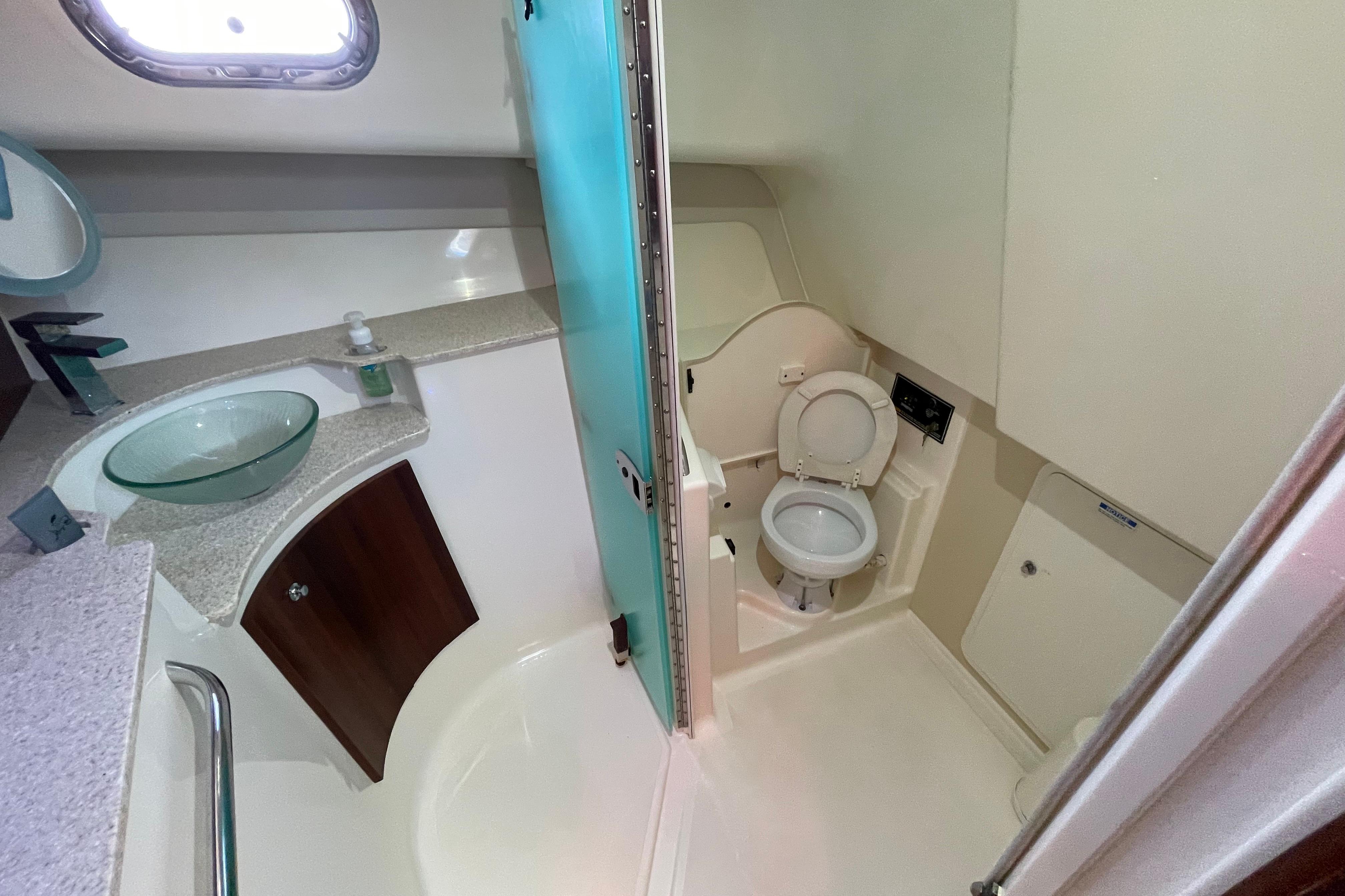 2010 Pursuit OS 375 Offshore boat bathroom with modern fixtures and glass sink.