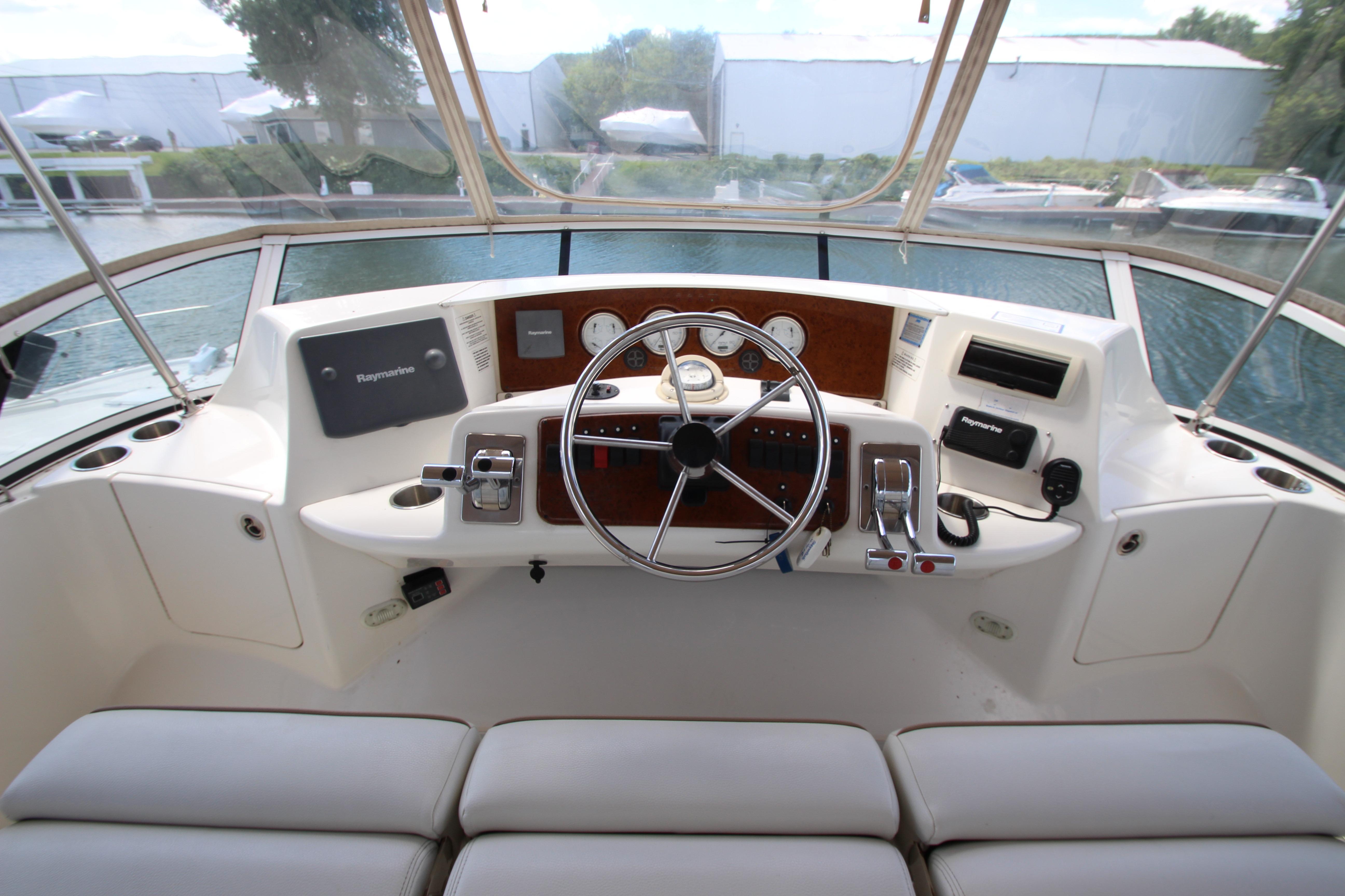 Helm of 2006 Silverton 38 Sport Bridge yacht with steering wheel and navigation instruments.