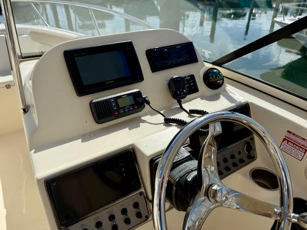 Control panel of a 2016 Scout 245 Dorado boat with steering wheel and navigation equipment.