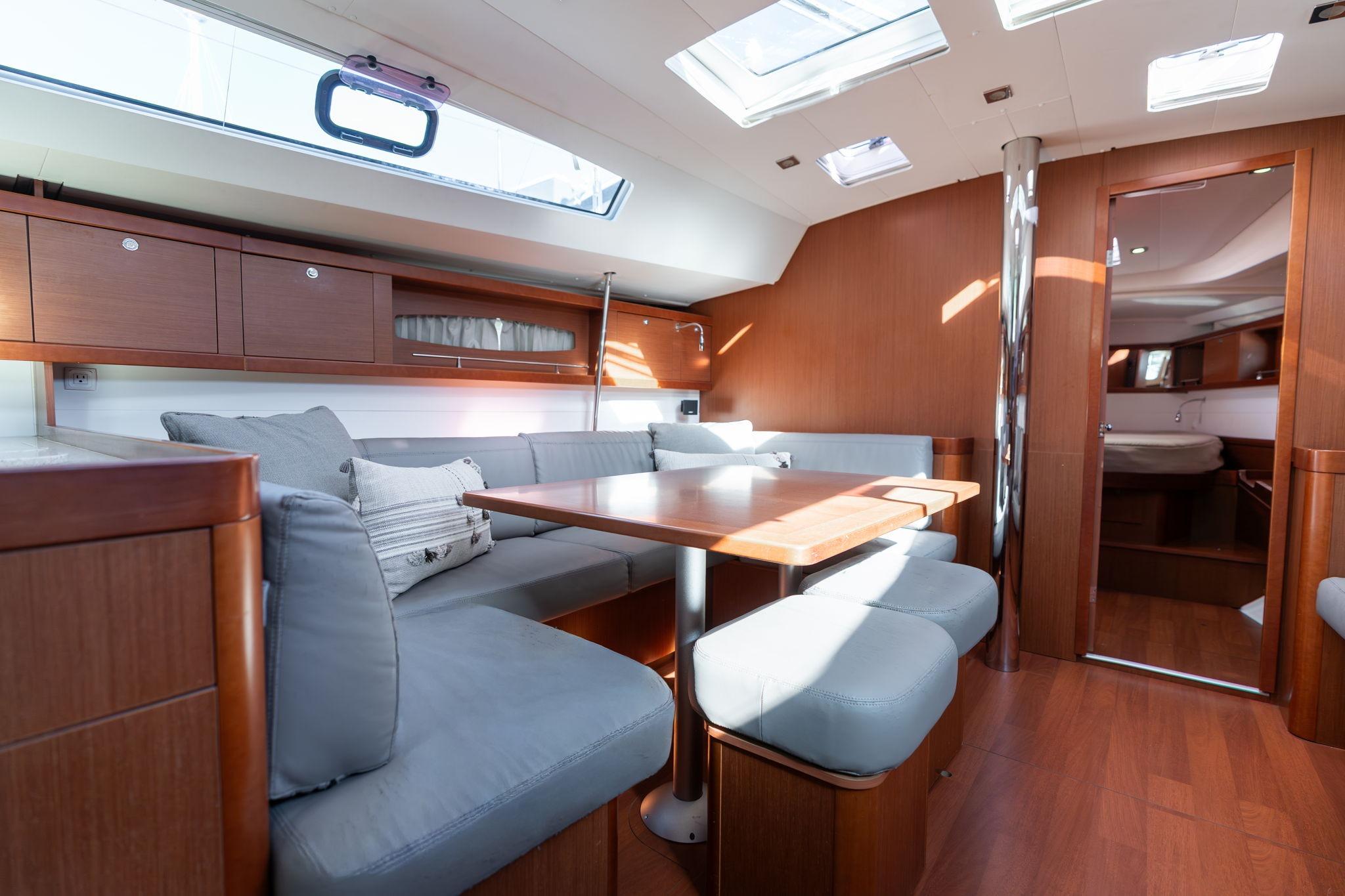 Luxurious interior of 2013 Beneteau Oceanis 50 yacht with elegant wood finish and skylights.