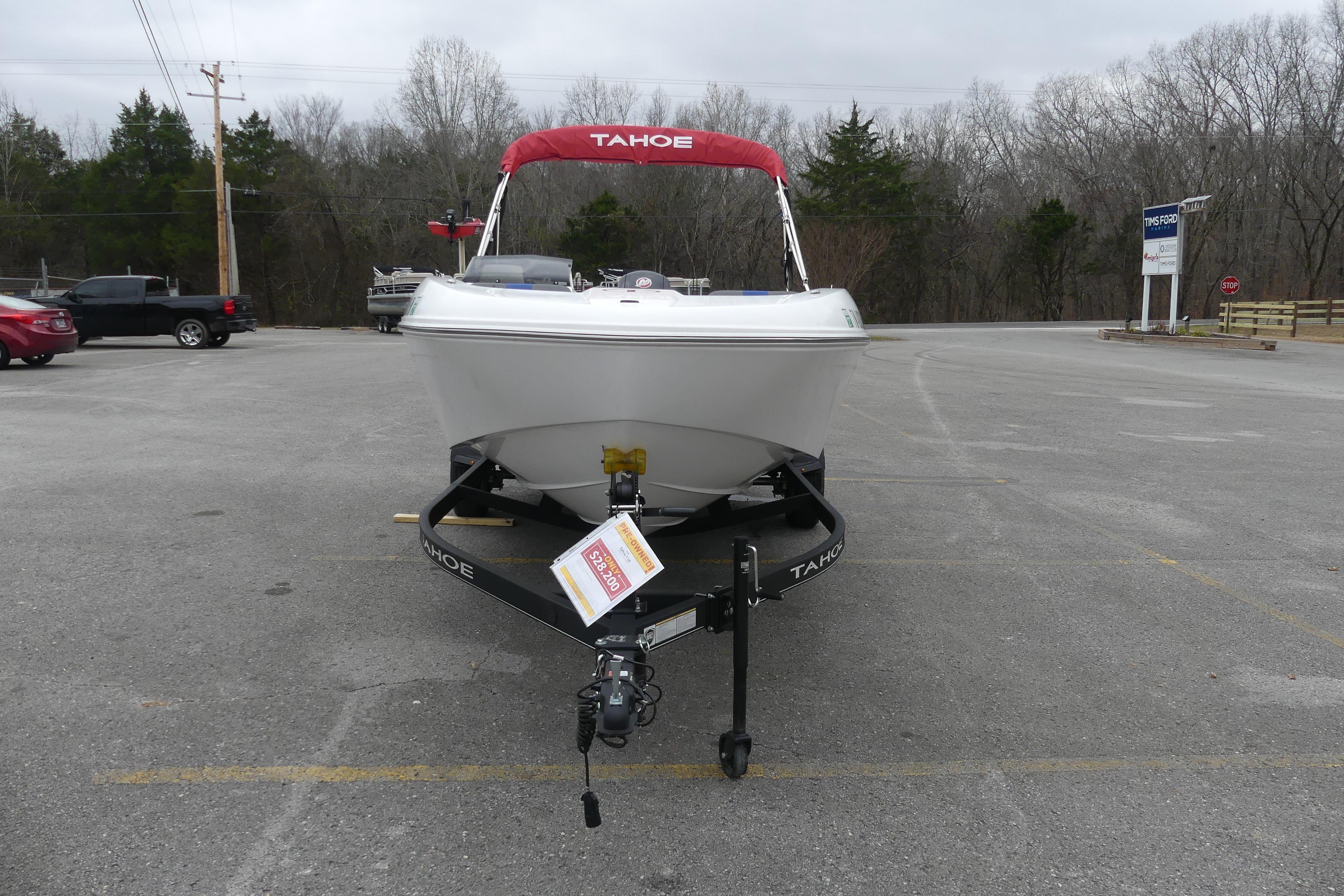 2024 Tahoe T18 boat on trailer in parking lot, overcast day.