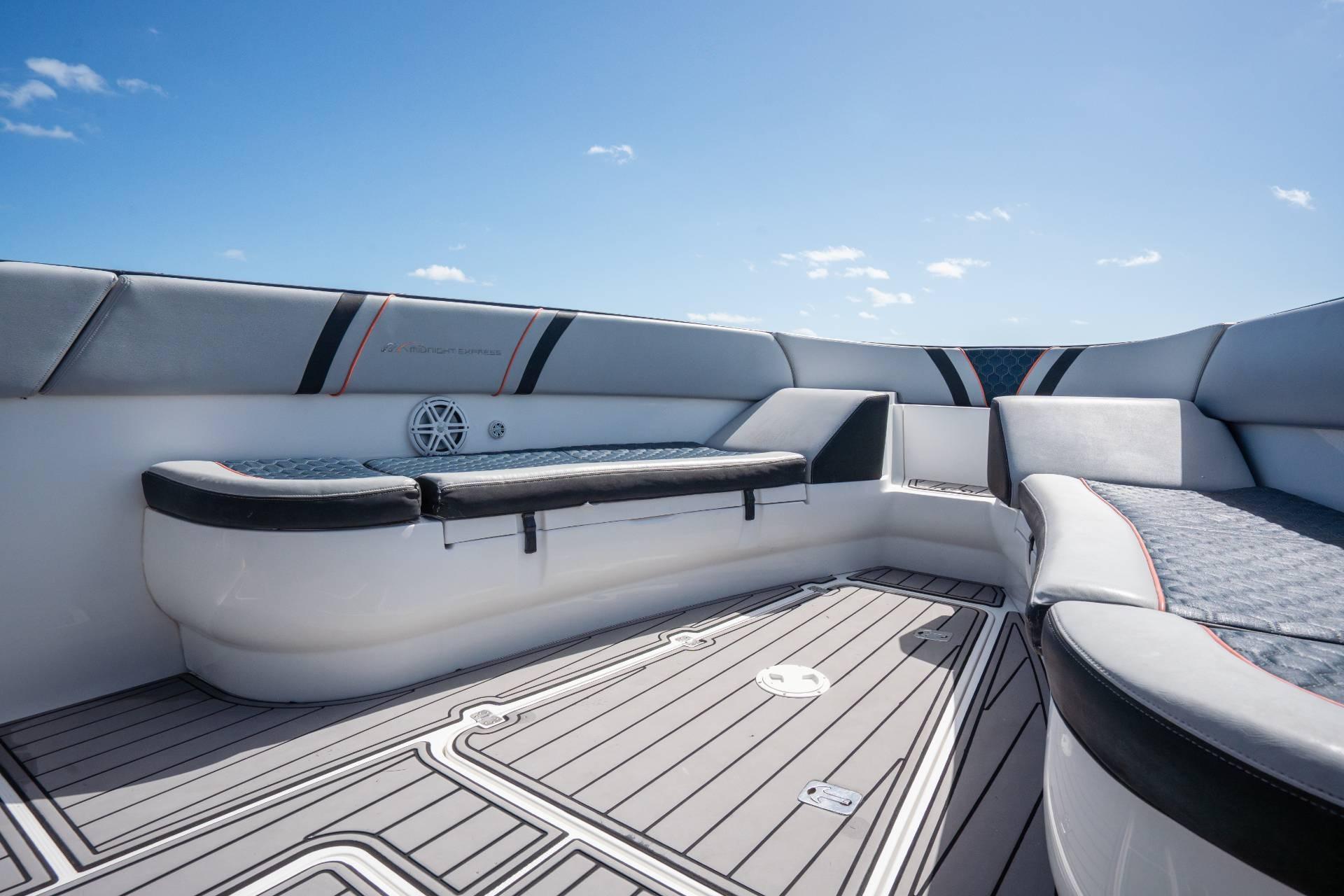 Interior view of 2014 Midnight Express 37 Open boat with cushioned seating and sleek design.