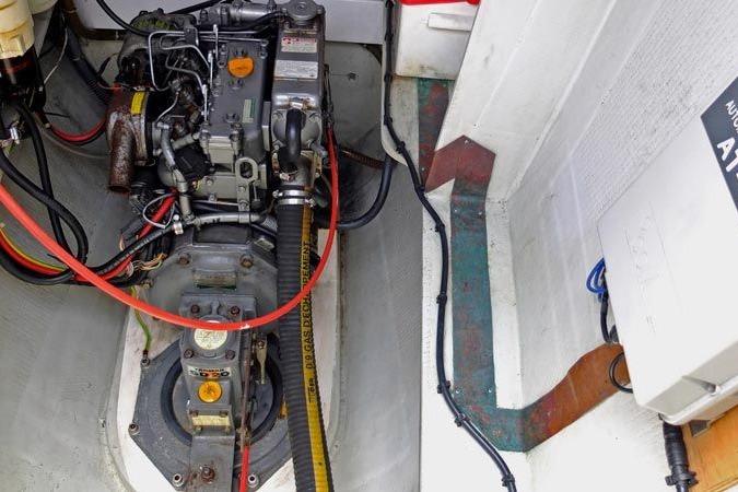 Engine compartment of a 2003 Outremer 45 catamaran, showcasing mechanical components and wiring.