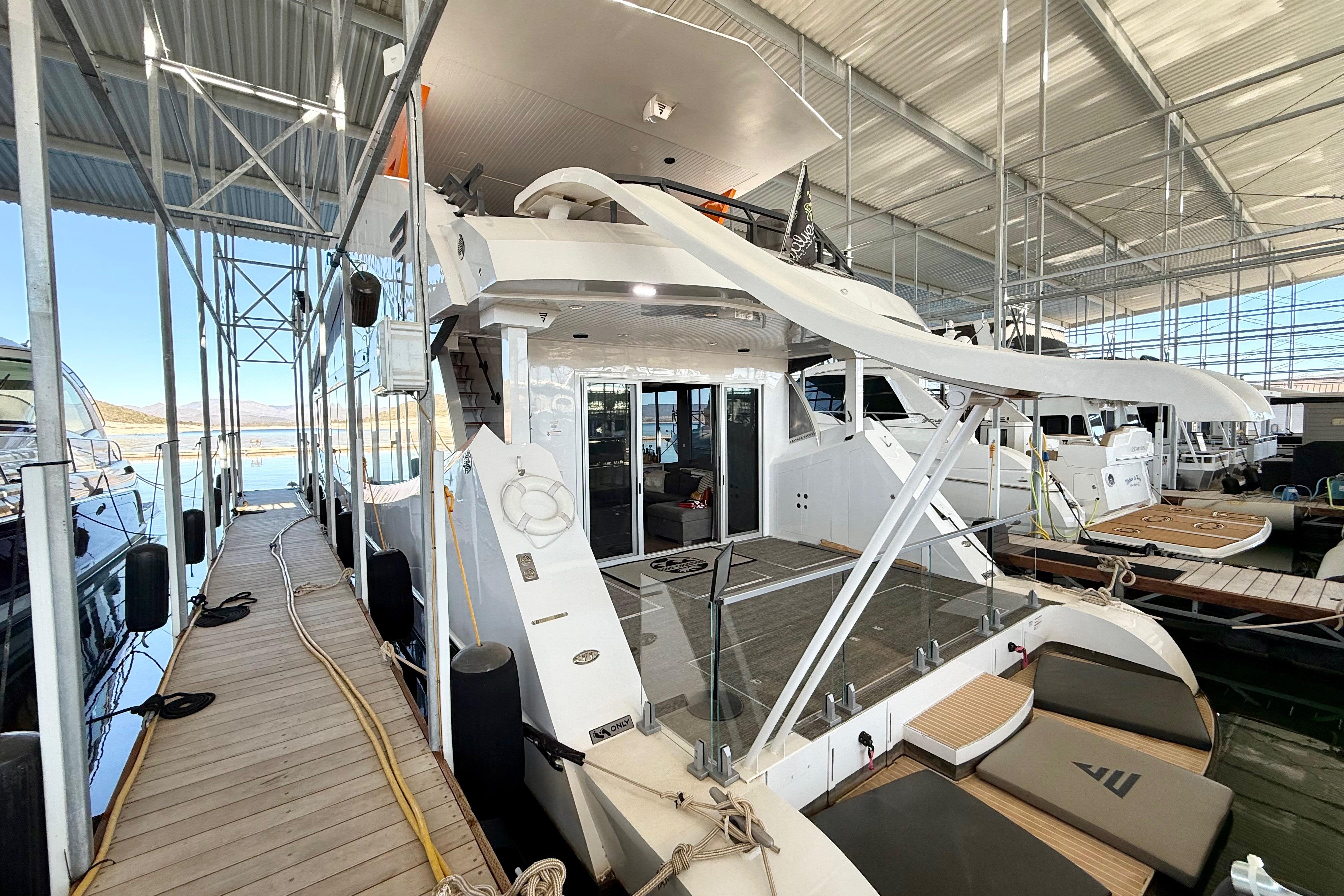 2021 BRAVADA YACHTS Atlas V Series 8018 docked in a marina, showcasing luxury design.