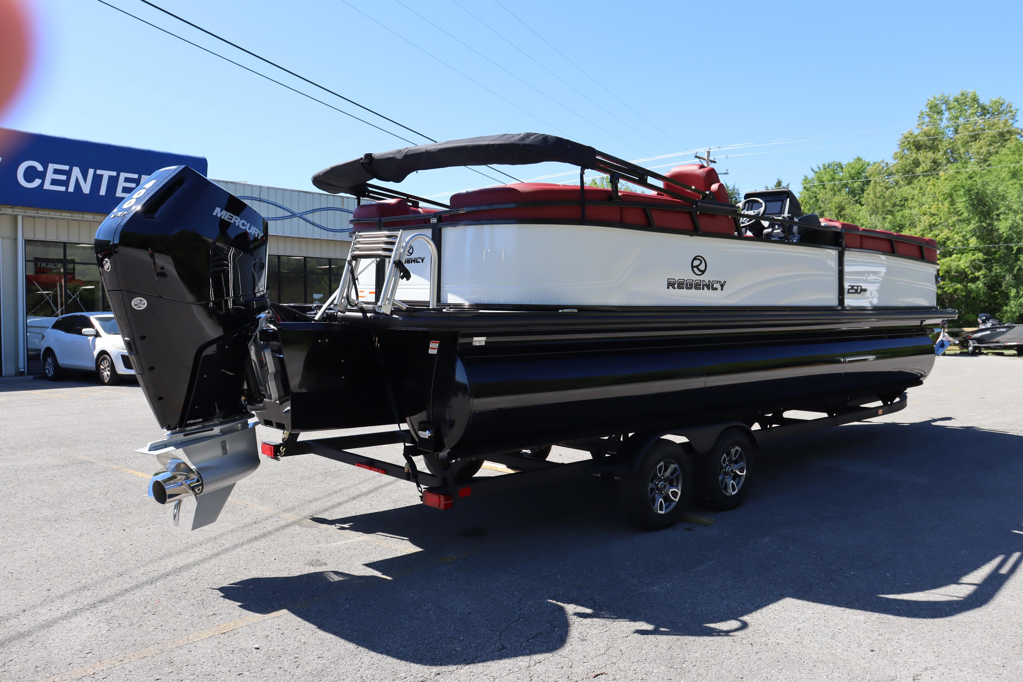 2026 Regency 250 DL pontoon boat with Mercury outboard motor on a trailer.
