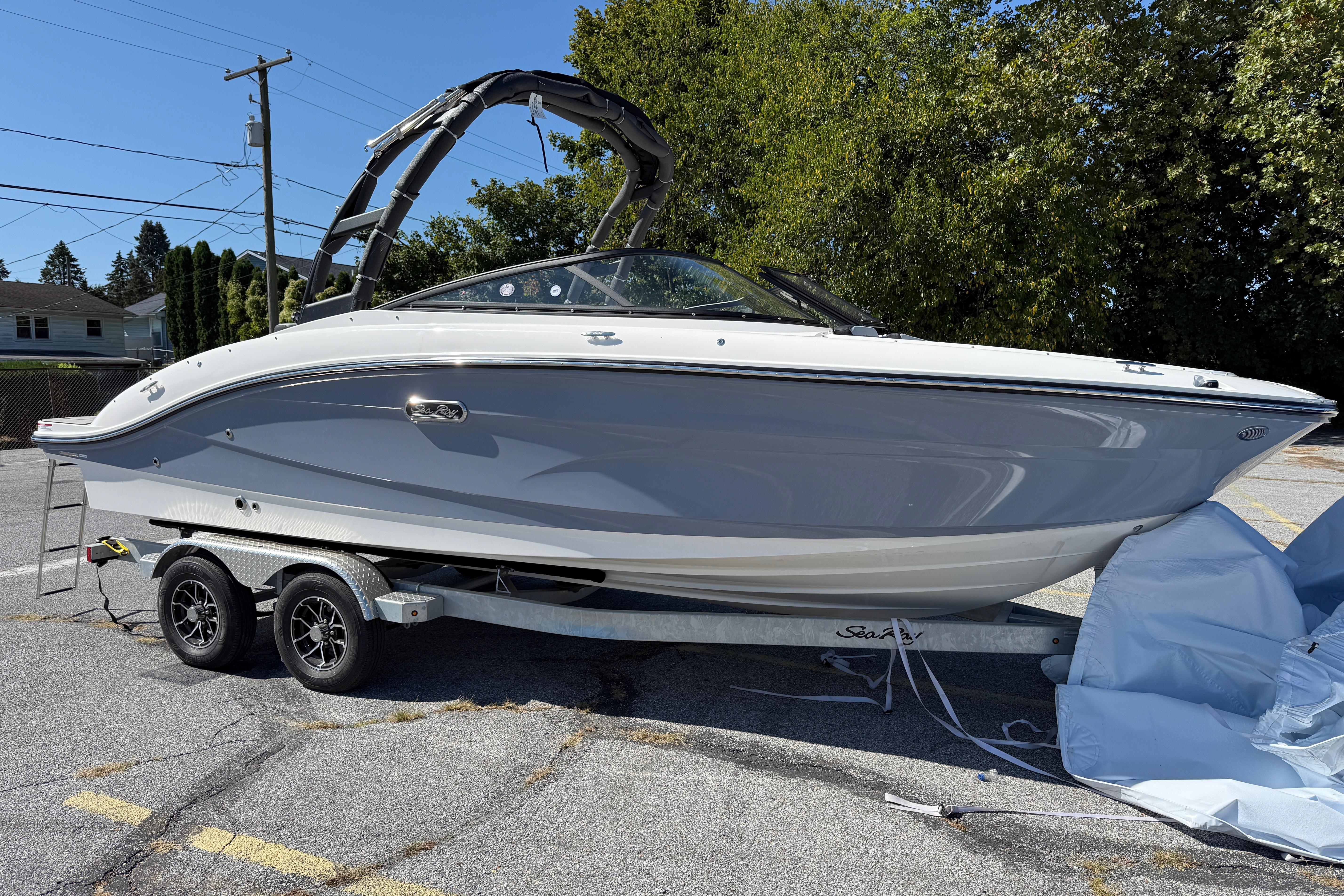 2026 Sea Ray SPX 210 boat on trailer, parked outdoors on a sunny day.