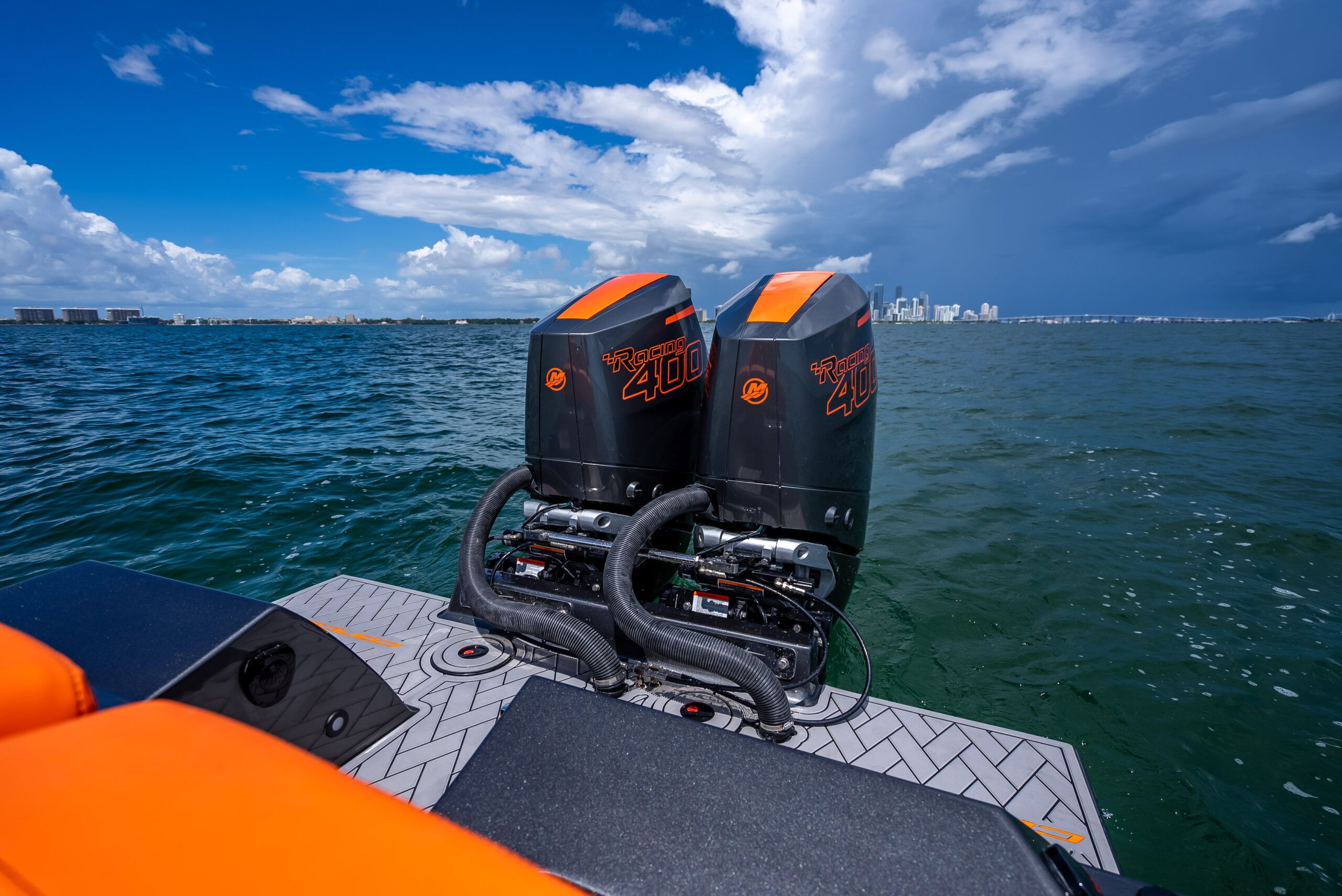 A modern sport boat with two powerful outboard engines on open water.