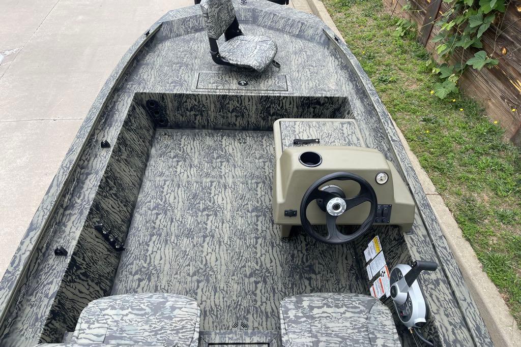 2026 Tracker Grizzly 1754 SC boat interior with camouflage design and steering console.