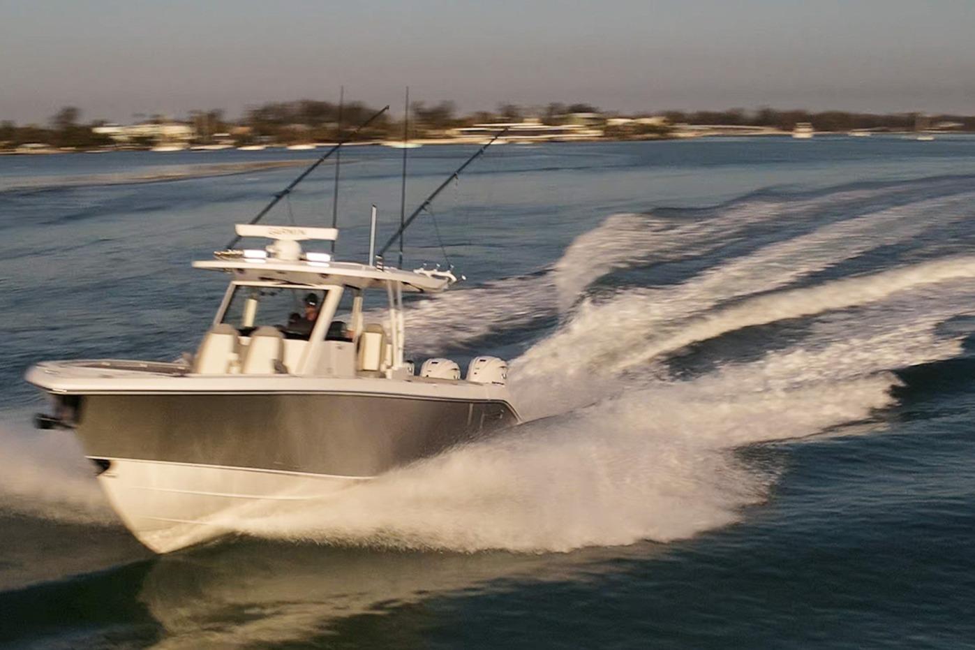 2024 Everglades 395 Center Console boat speeding on open water.