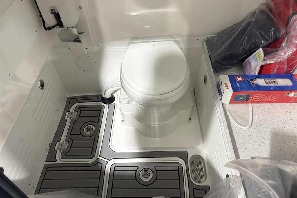 2026 Tidewater 3100 Carolina Bay boat interior with toilet and storage area.