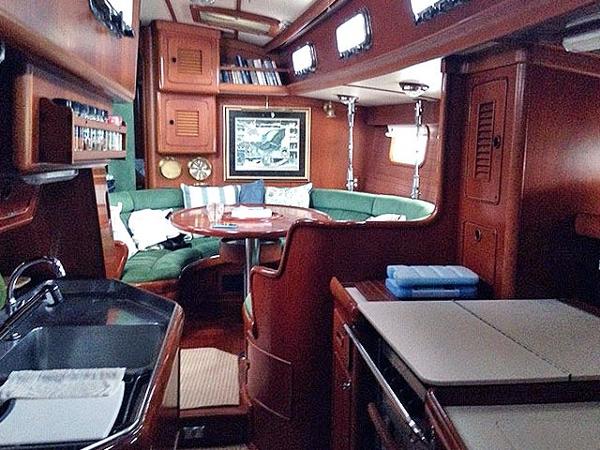 Interior of a 1988 Little Harbor 53 with wood finish and cozy seating area.
