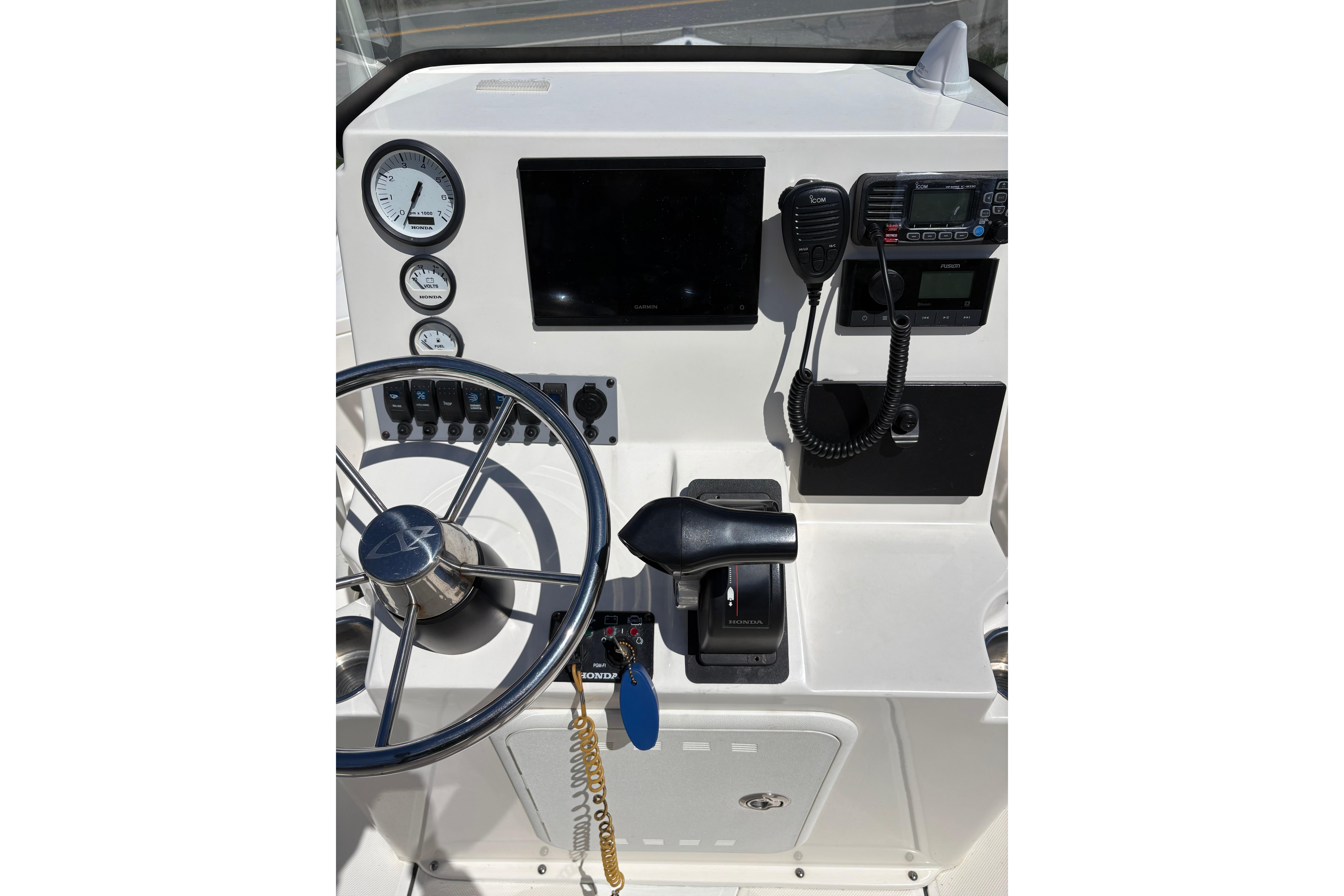 2021 Sea Born FX21 Bay boat console with steering wheel, gauges, and controls.