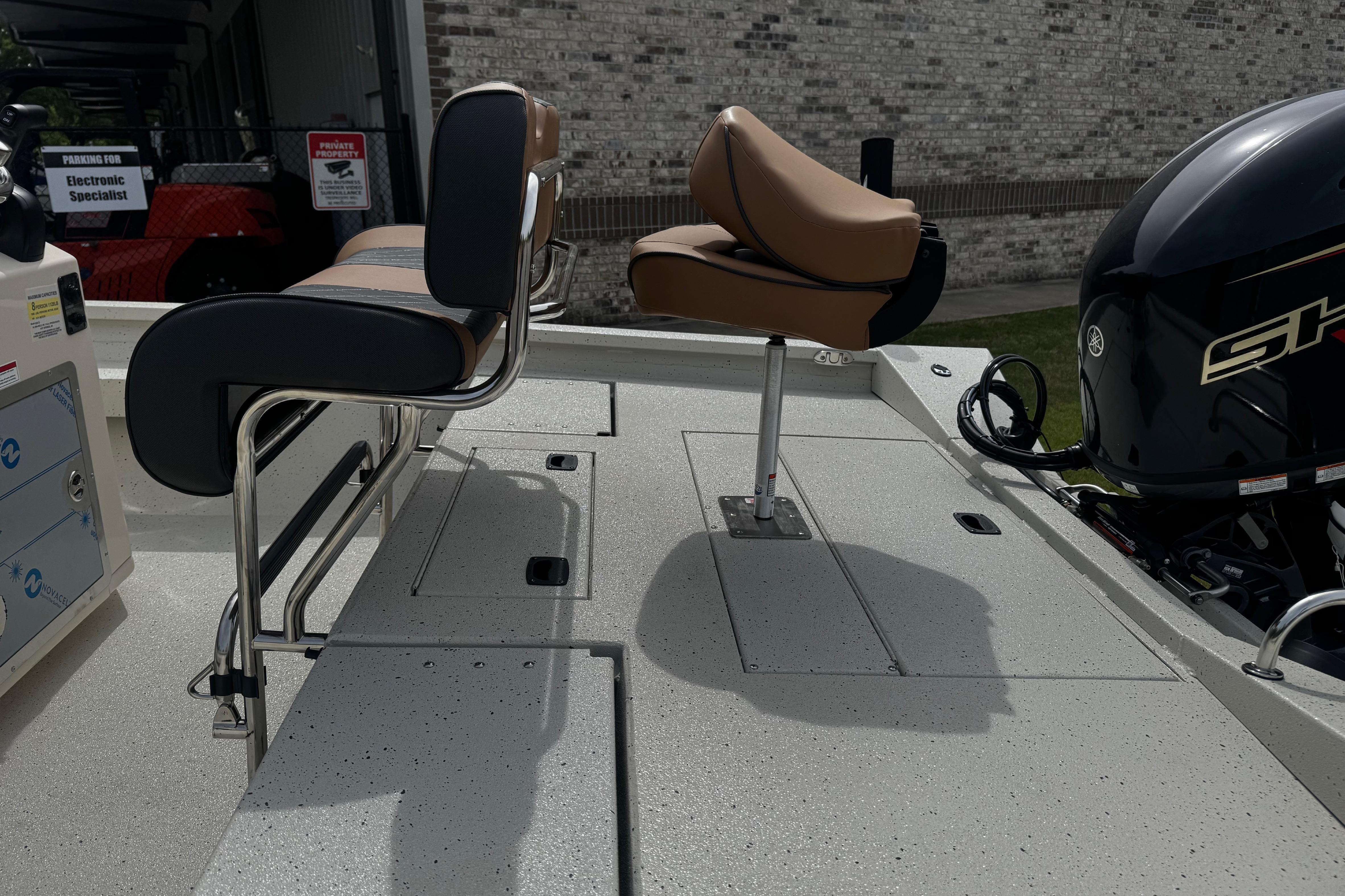 2026 Xpress H20B Bay boat interior with seating and motor detail.