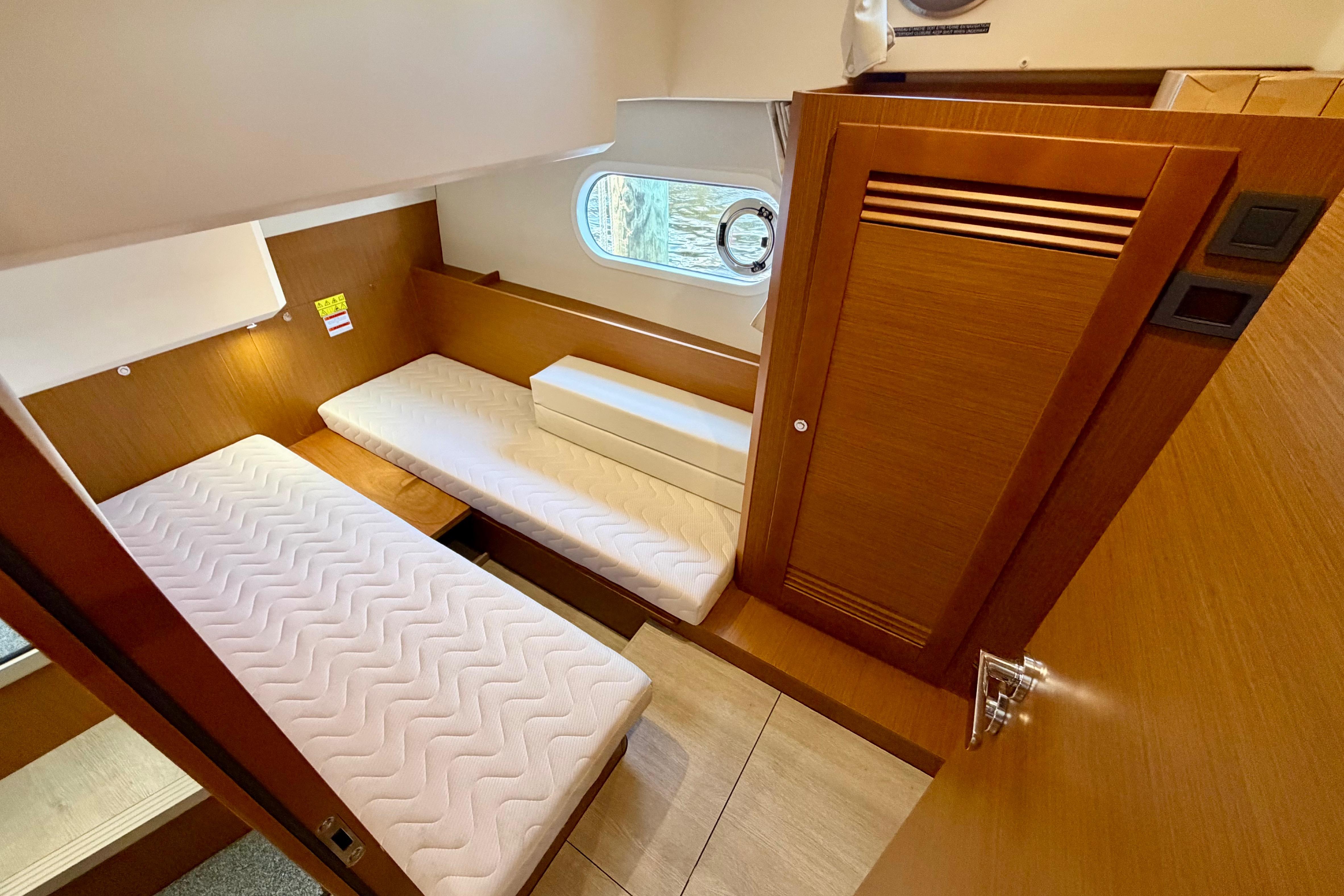 2025 Beneteau Swift Trawler 41 Fly cabin interior with twin beds and wooden finish.