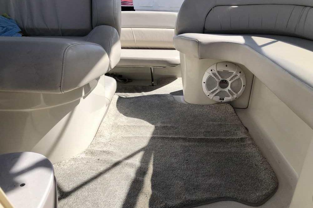 Interior of a 1999 Regal Commodore 2760 boat with gray seating and carpet.