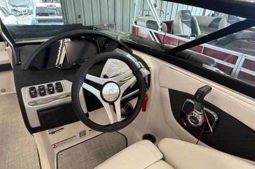 2027 Regal 2000 ES boat interior with steering wheel and control panel in a marina setting.