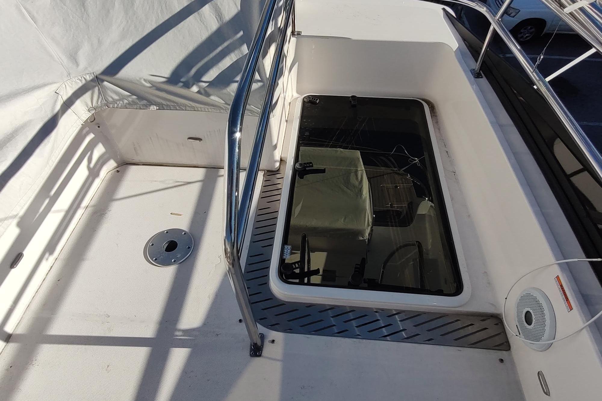 2021 Regal 42 Fly yacht deck with railing and hatch, showcasing modern design.