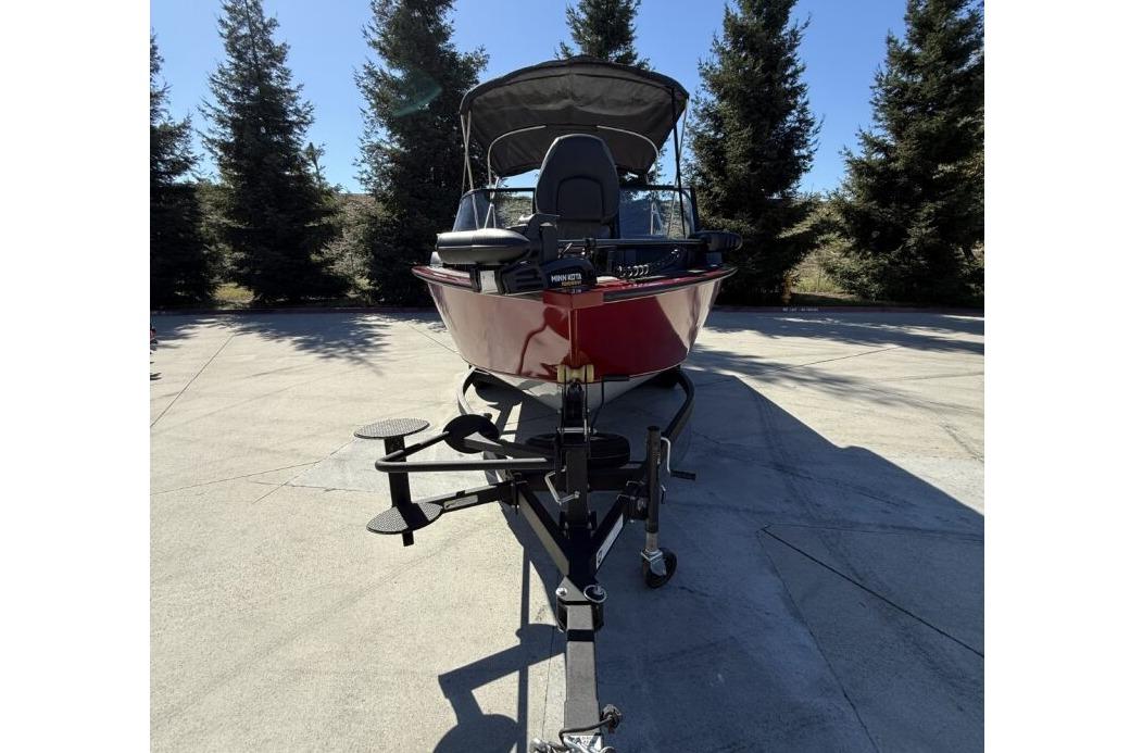 2024 Tracker Targa V-19 WT boat on trailer, parked outdoors with trees in background.