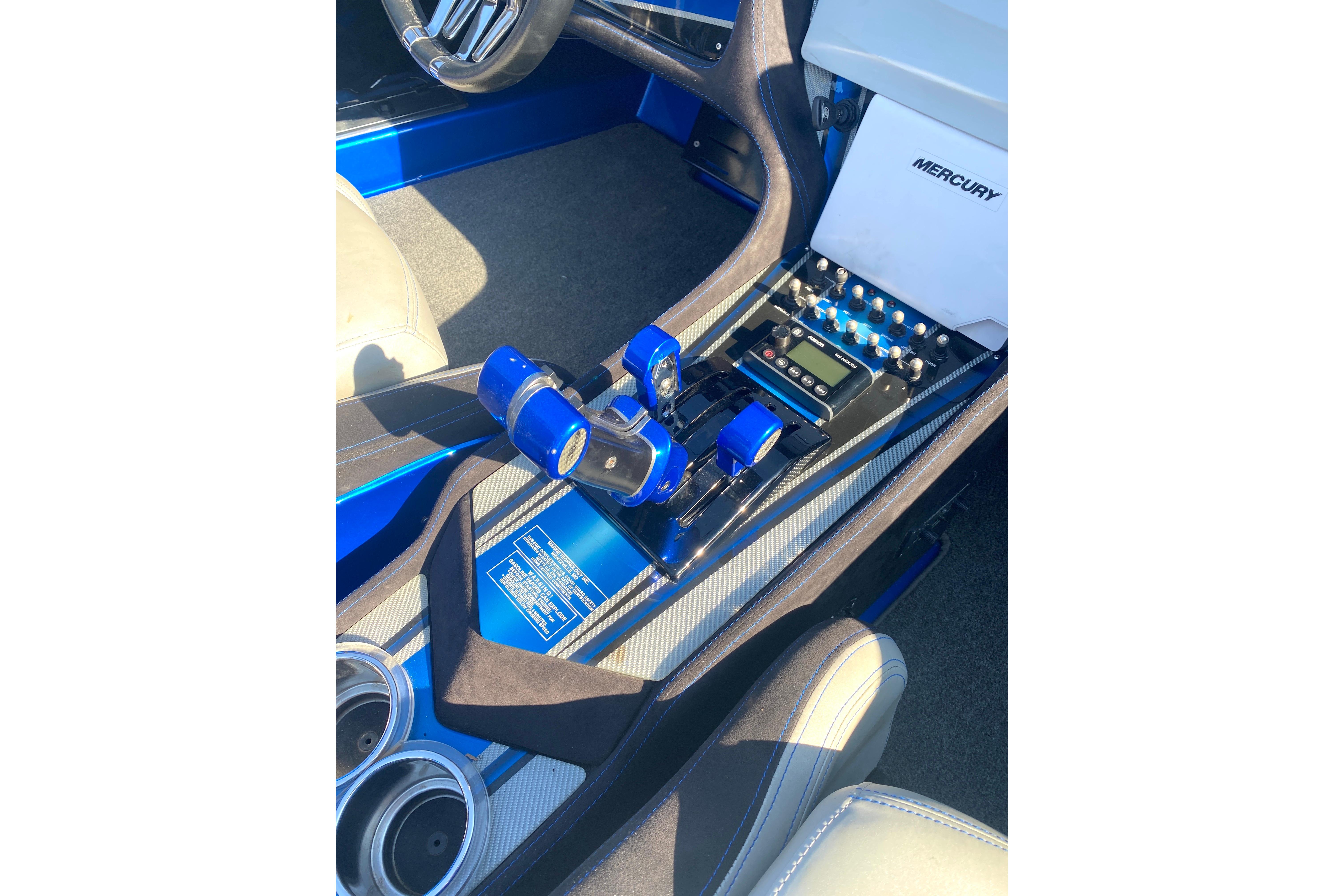Interior of a 2016 MTI 44 RP boat featuring control panel and Mercury branding.