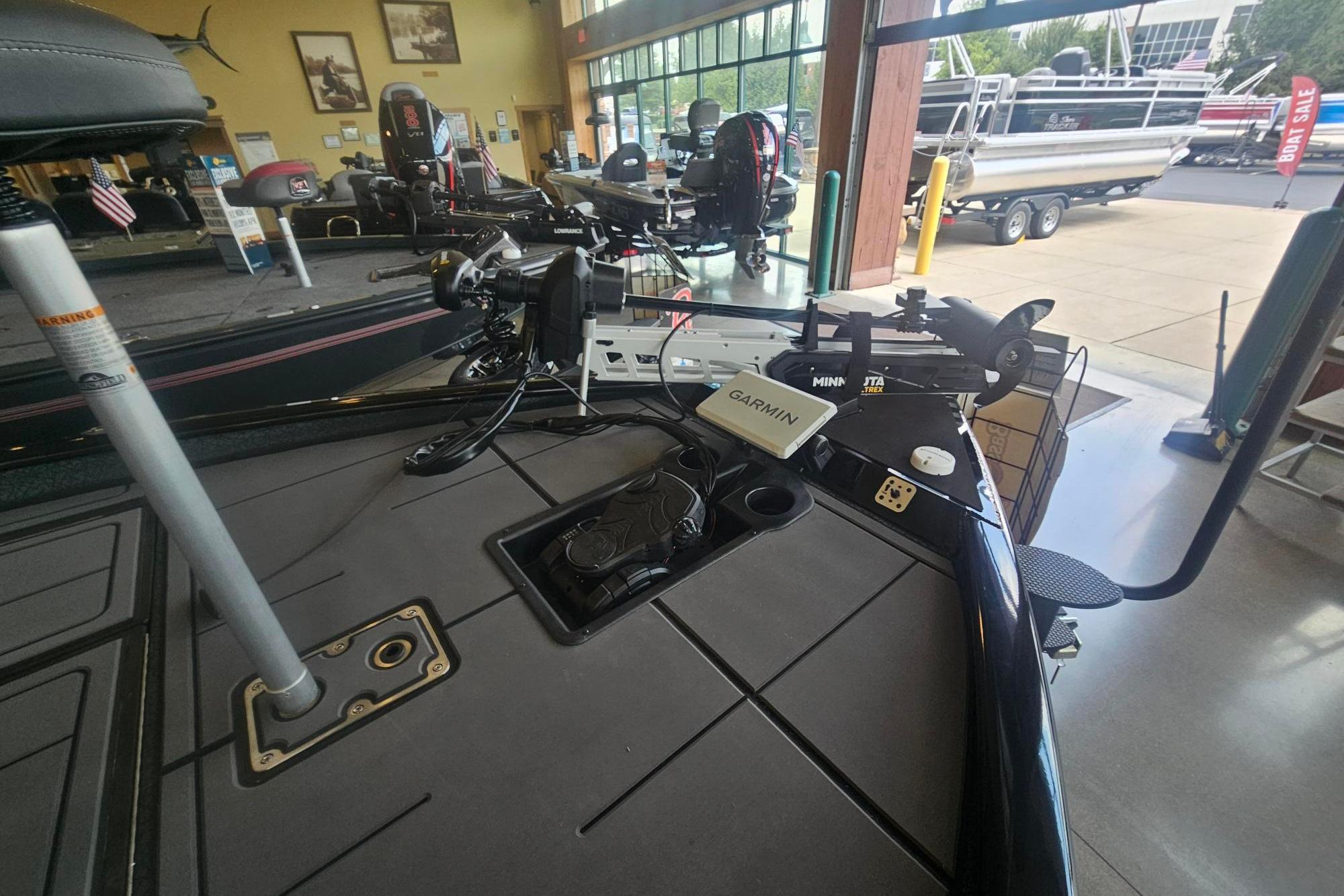 2026 Tracker Savage 215 boat interior with Garmin and Minn Kota equipment in showroom.