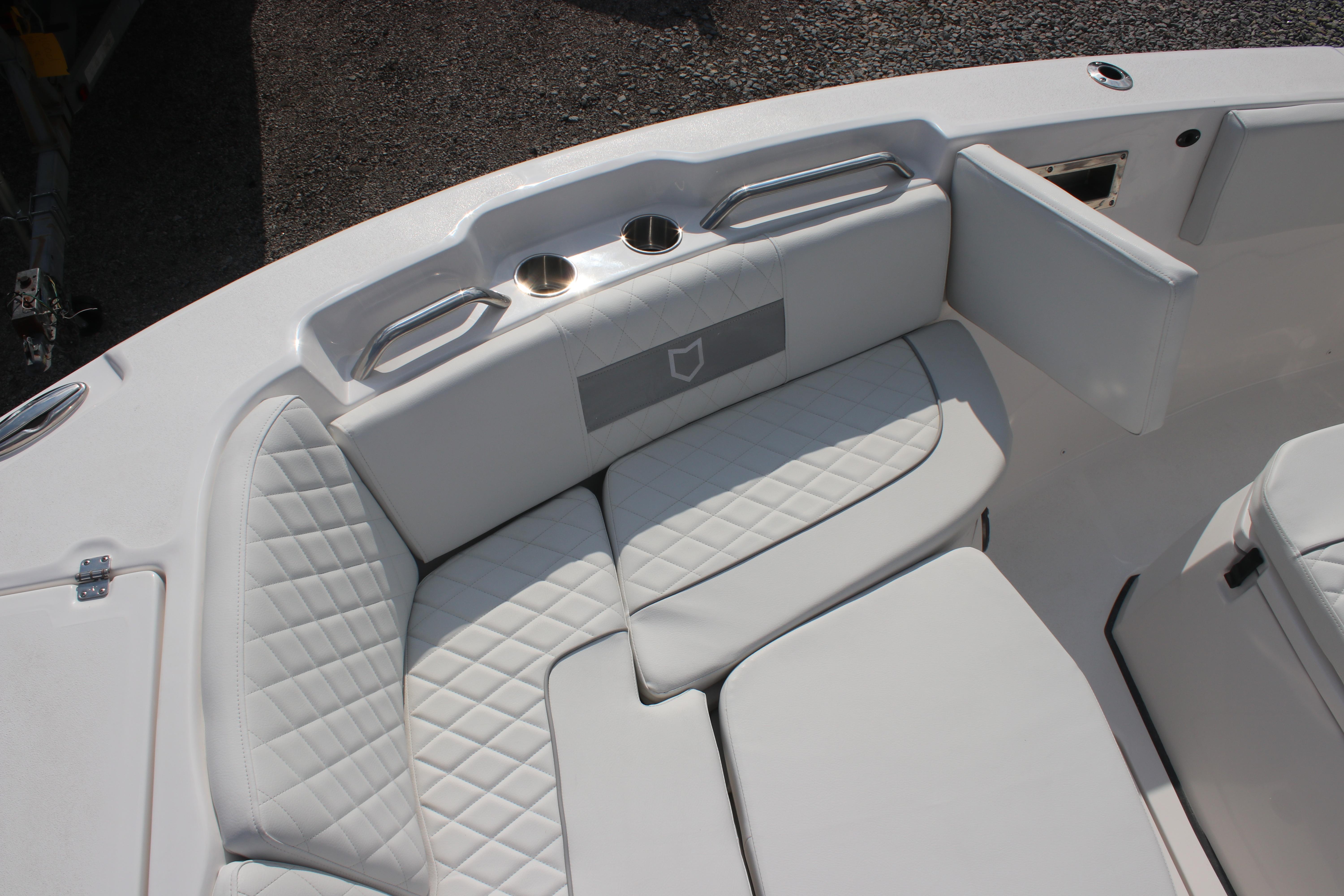 Luxurious seating on 2026 Sea Fox 268 Commander boat with quilted white upholstery.
