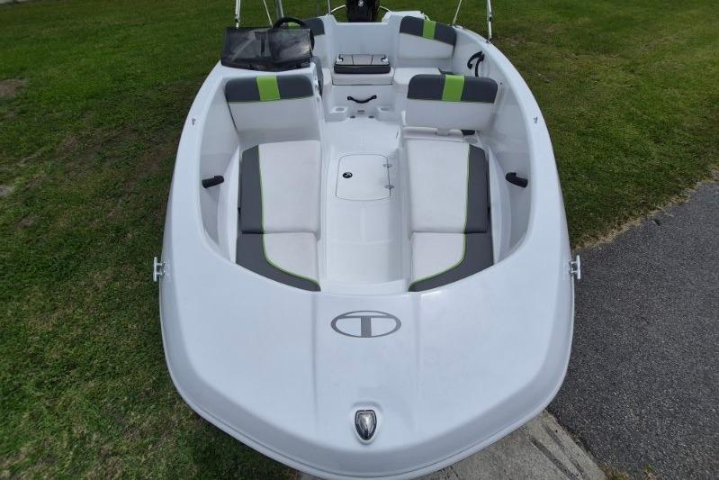 2021 Tahoe T16 boat with green accents, parked on grass.