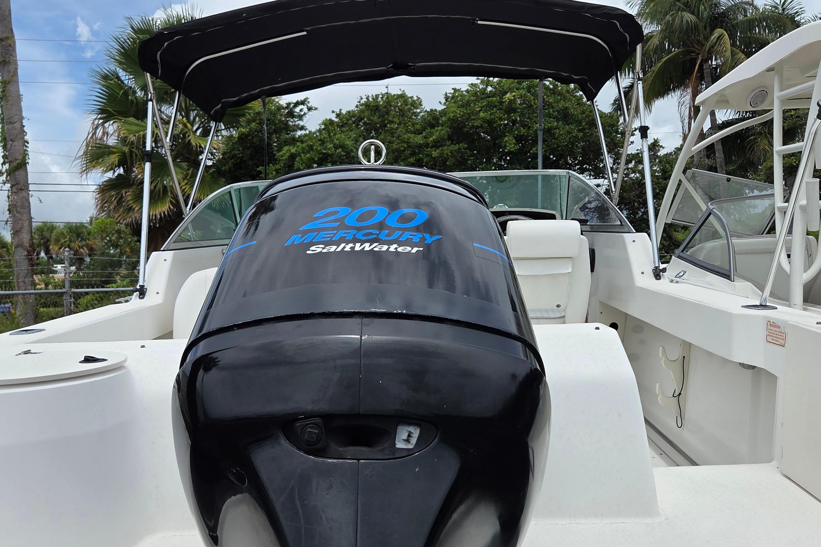 2000 Boston Whaler 21 Ventura boat with Mercury 200 SaltWater engine, under canopy.