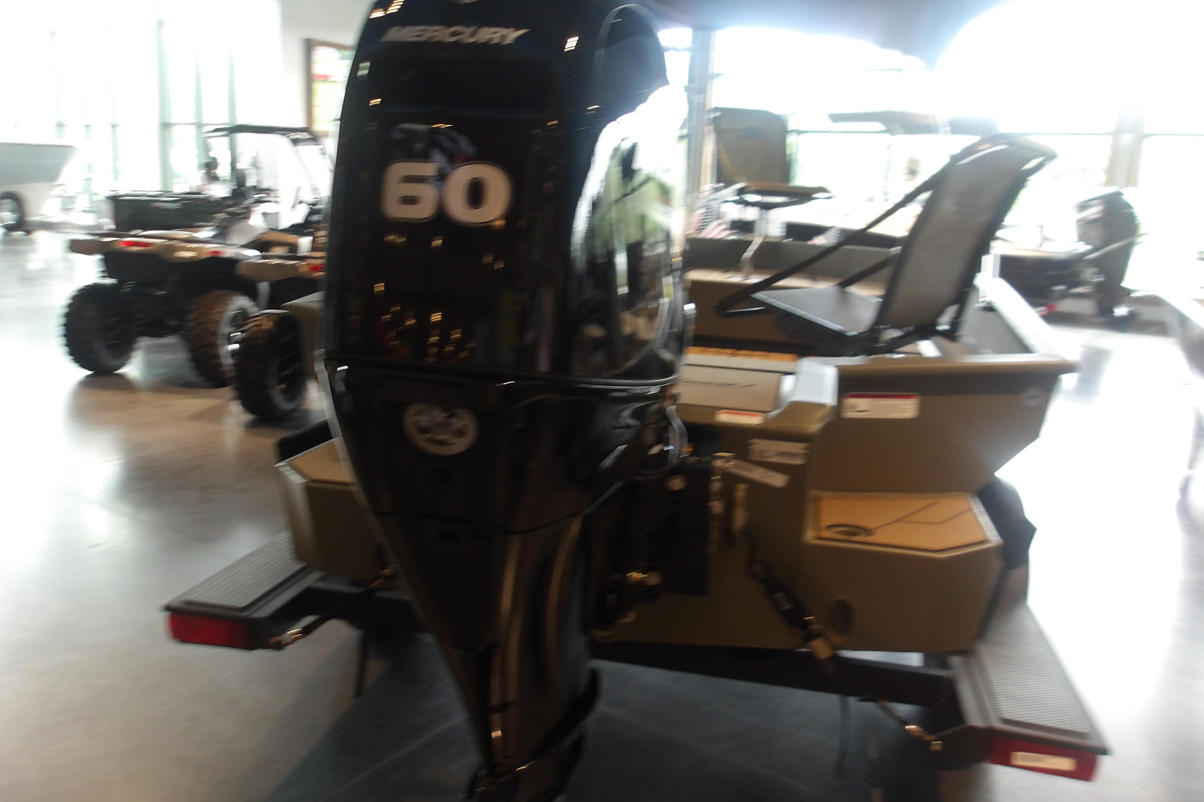 2026 Tracker Grizzly 1756 T Marsh boat with Mercury 60 engine in showroom.