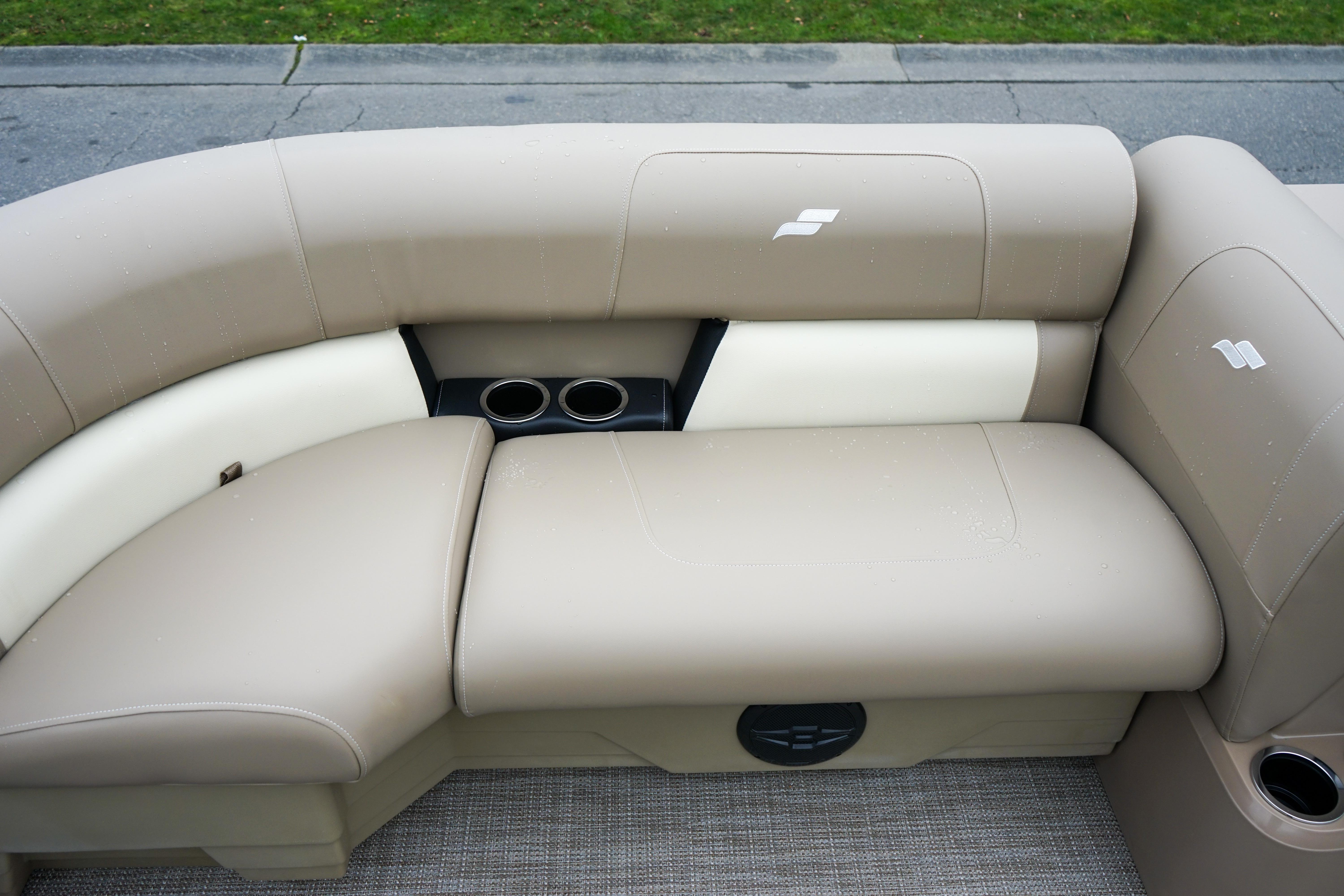 Luxurious beige seating on 2025 Starcraft LX16R boat with cup holders.