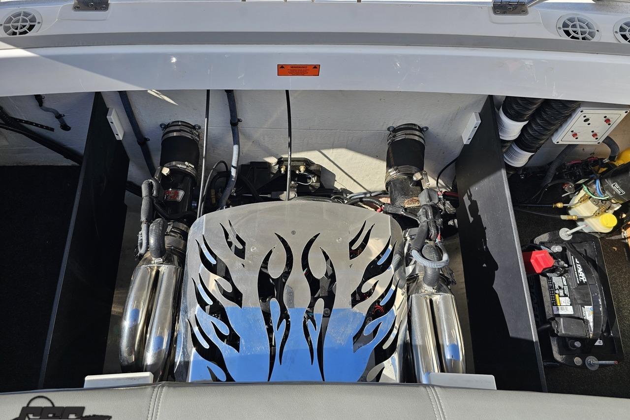 Engine compartment of a 2006 Powerquest 240 Ultra LX boat with custom flame design.