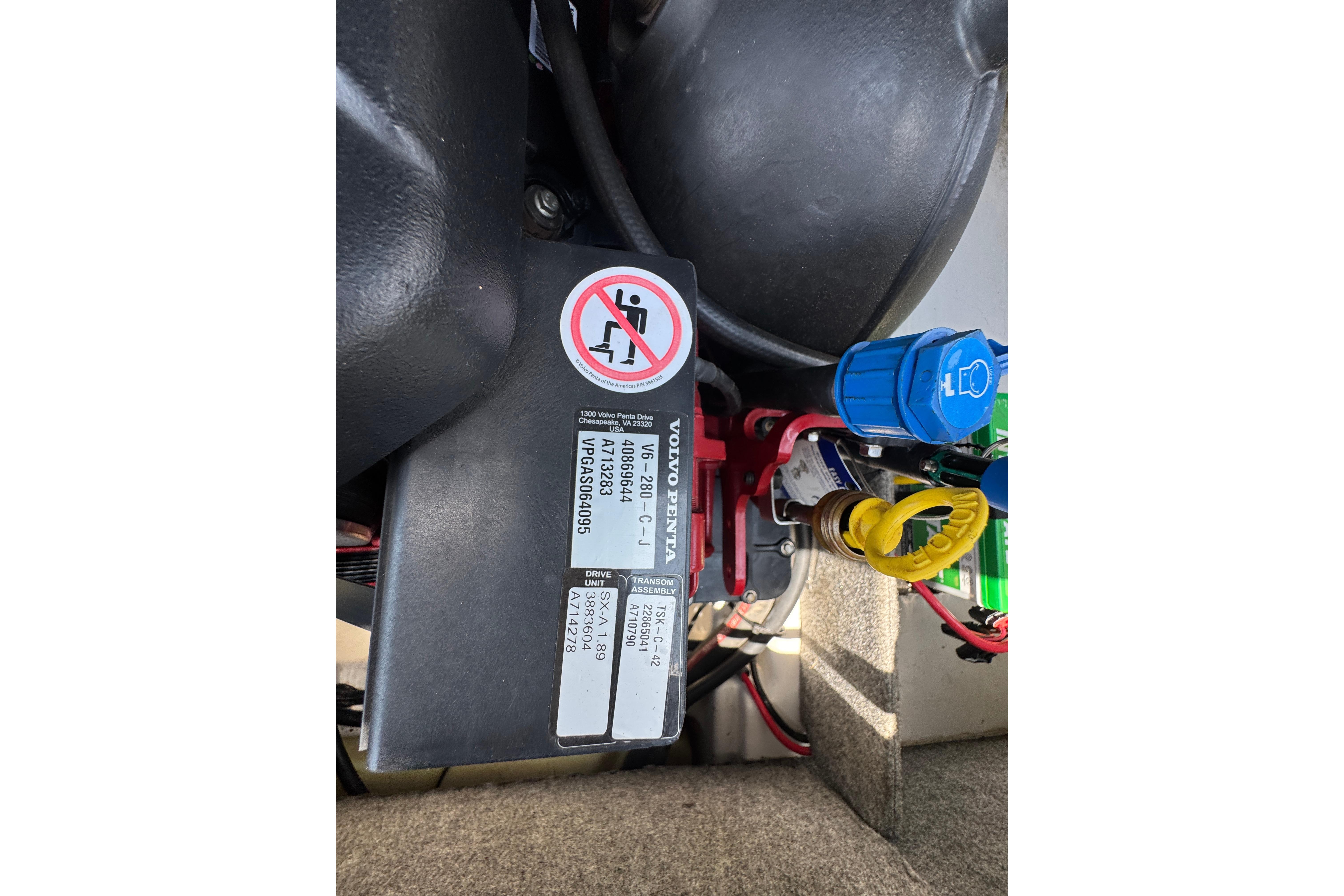 2017 Glastron GT 225 engine compartment with wiring and warning labels.