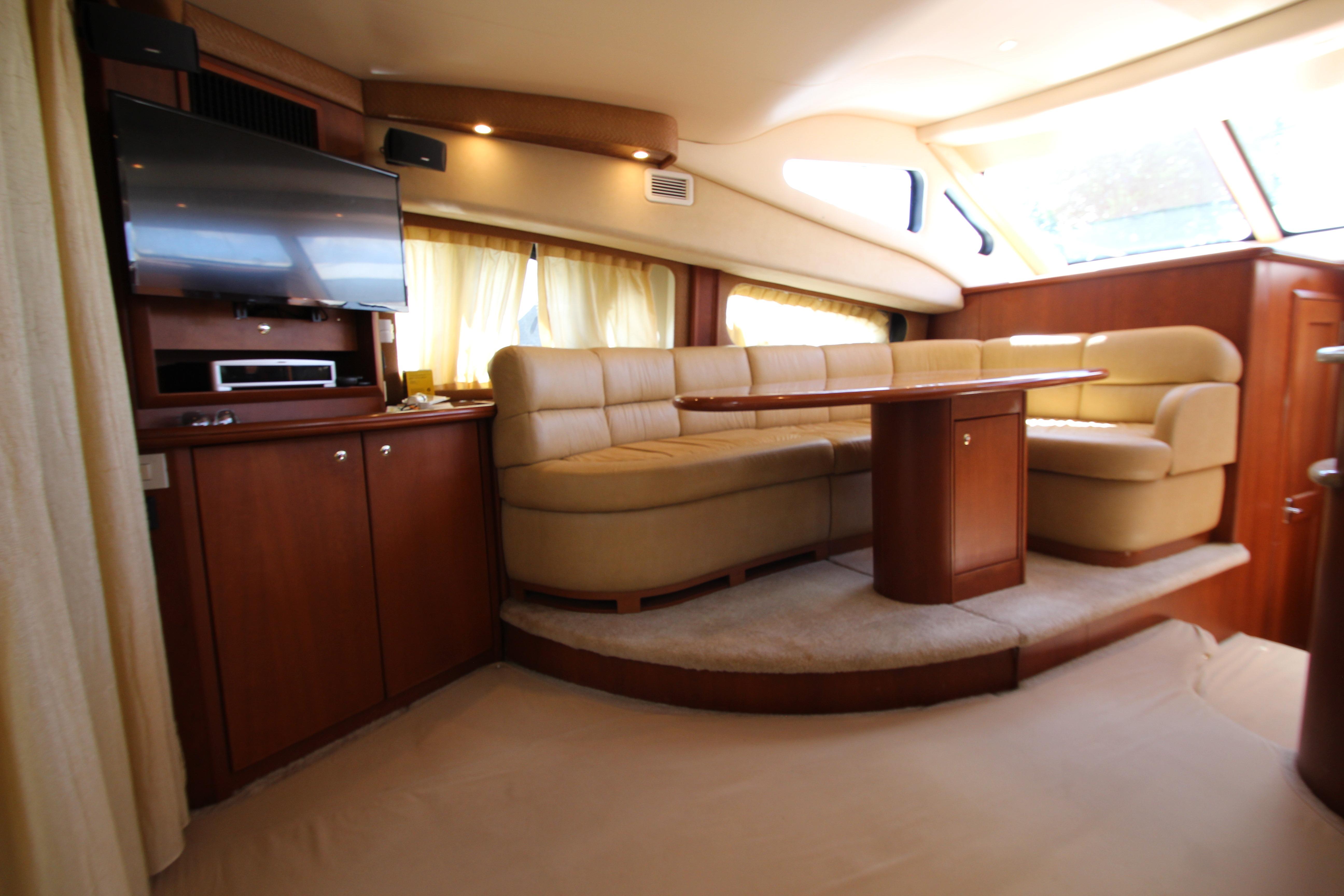 Luxurious interior of a 2006 Silverton 38 Sport Bridge yacht with plush seating and entertainment area.