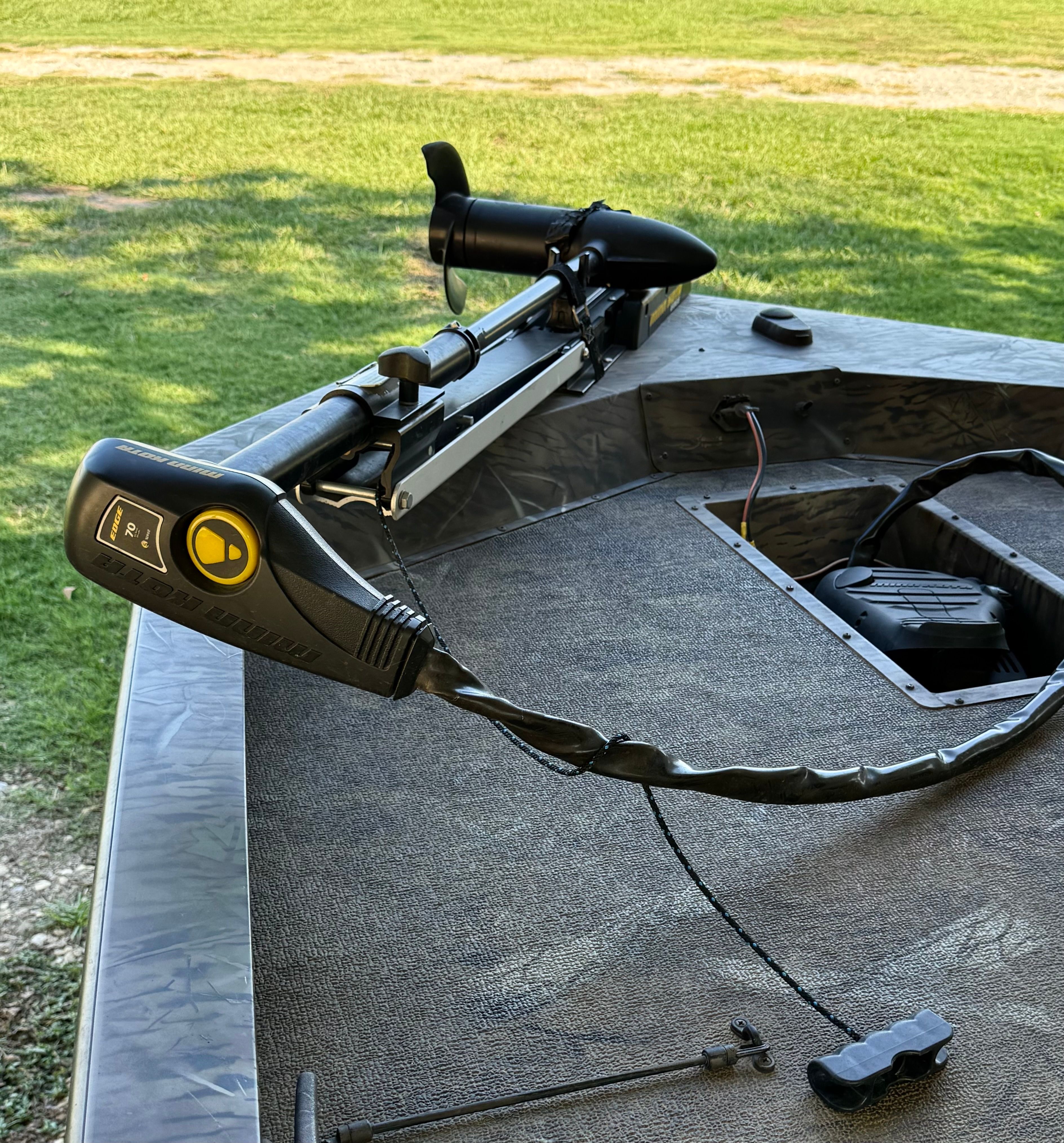 Close-up of the bow of a G3 Sportsman 17 Camo boat with a mounted motor.
