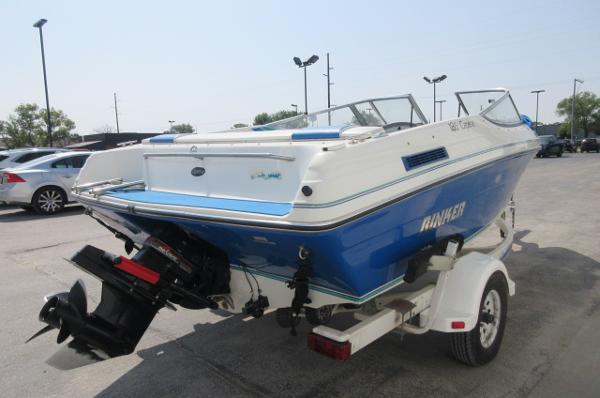 1993 Rinker 186 Captiva boat on trailer, blue and white, rear view.