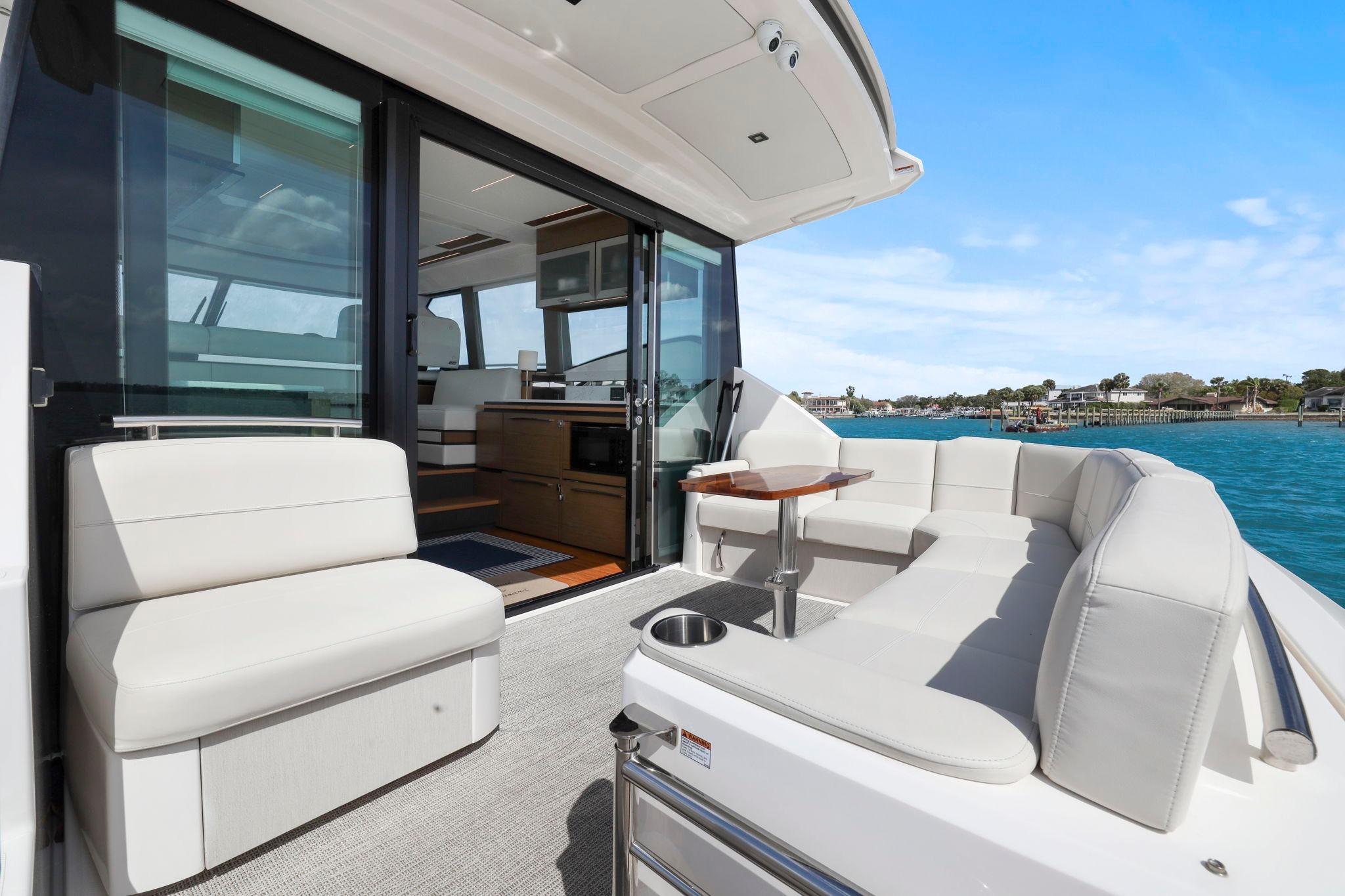 Luxurious 2023 Tiara Yachts C49 Coupe with elegant seating and ocean view.