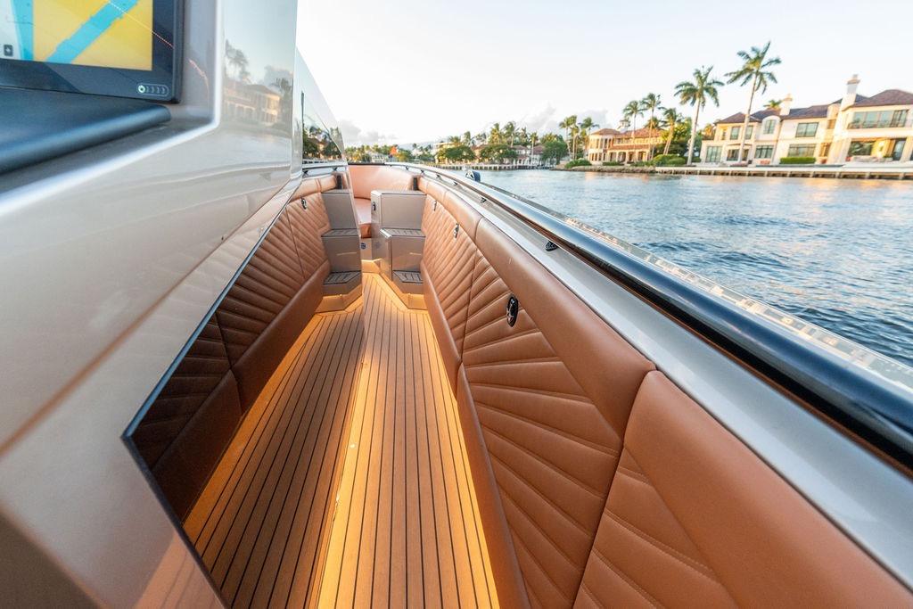 Luxurious 2023 DeKoning 43 yacht interior with elegant seating and waterfront view.