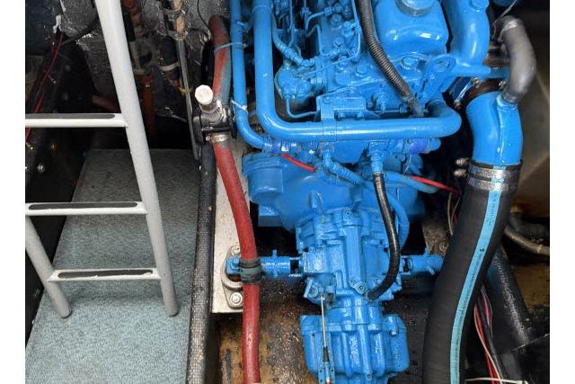 Engine compartment of a 1982 Lancer 45 Motorsailer with blue-painted engine components.